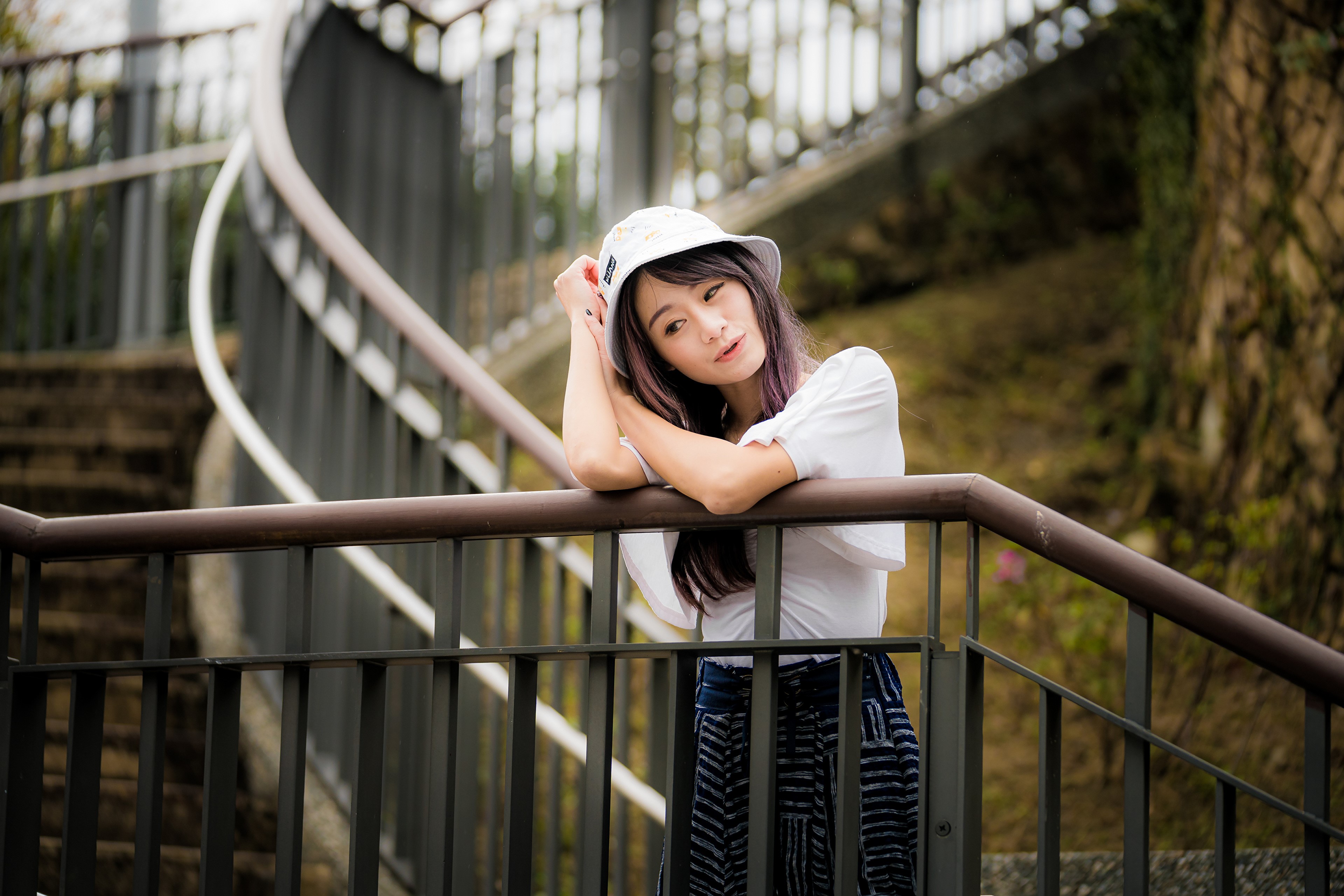Asian woman in hat on stairs HD Wallpaper
