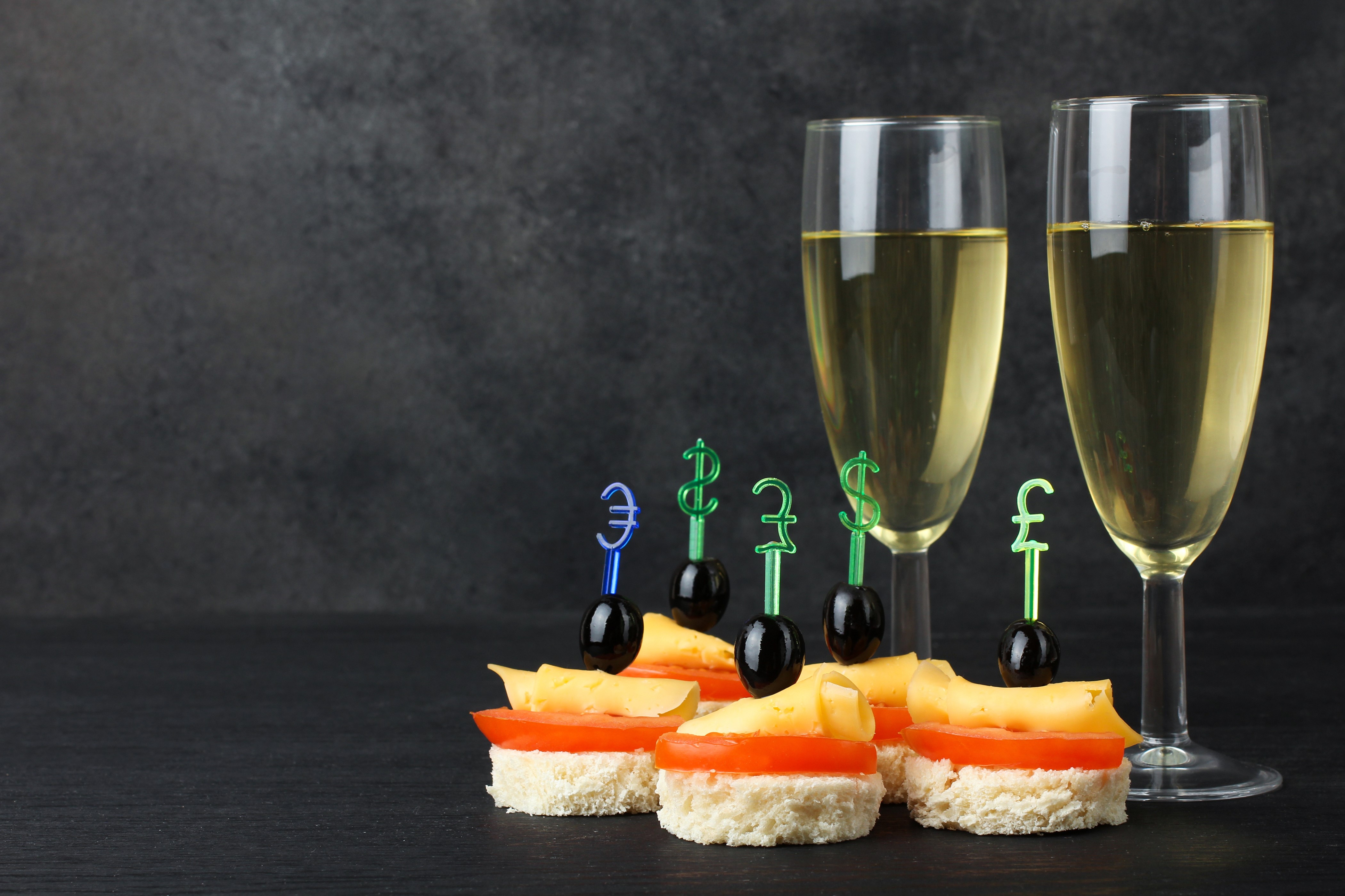 Appetizers with champagne and currency symbols HD Wallpaper