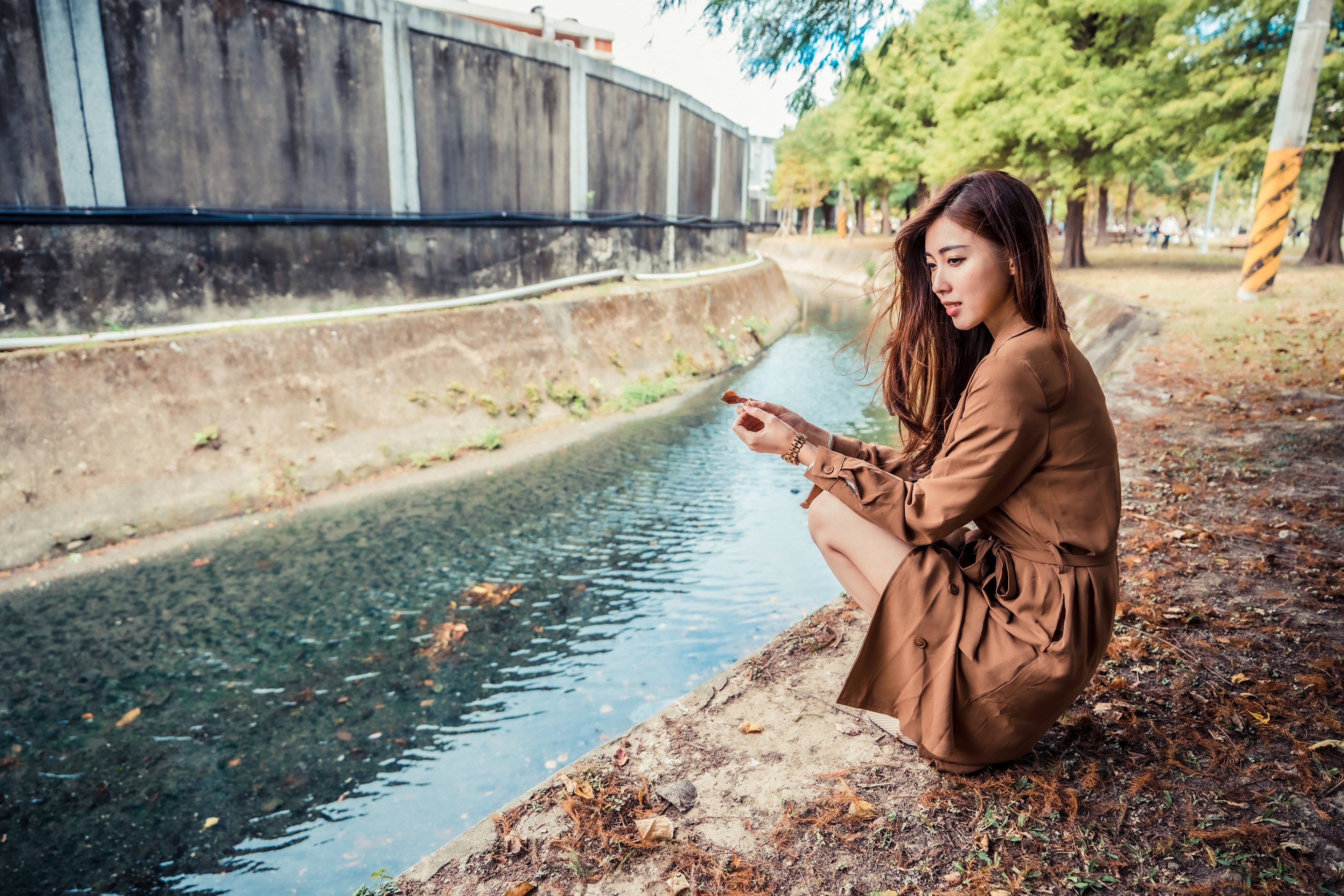 Asian woman in brown dress by canal HD Wallpaper