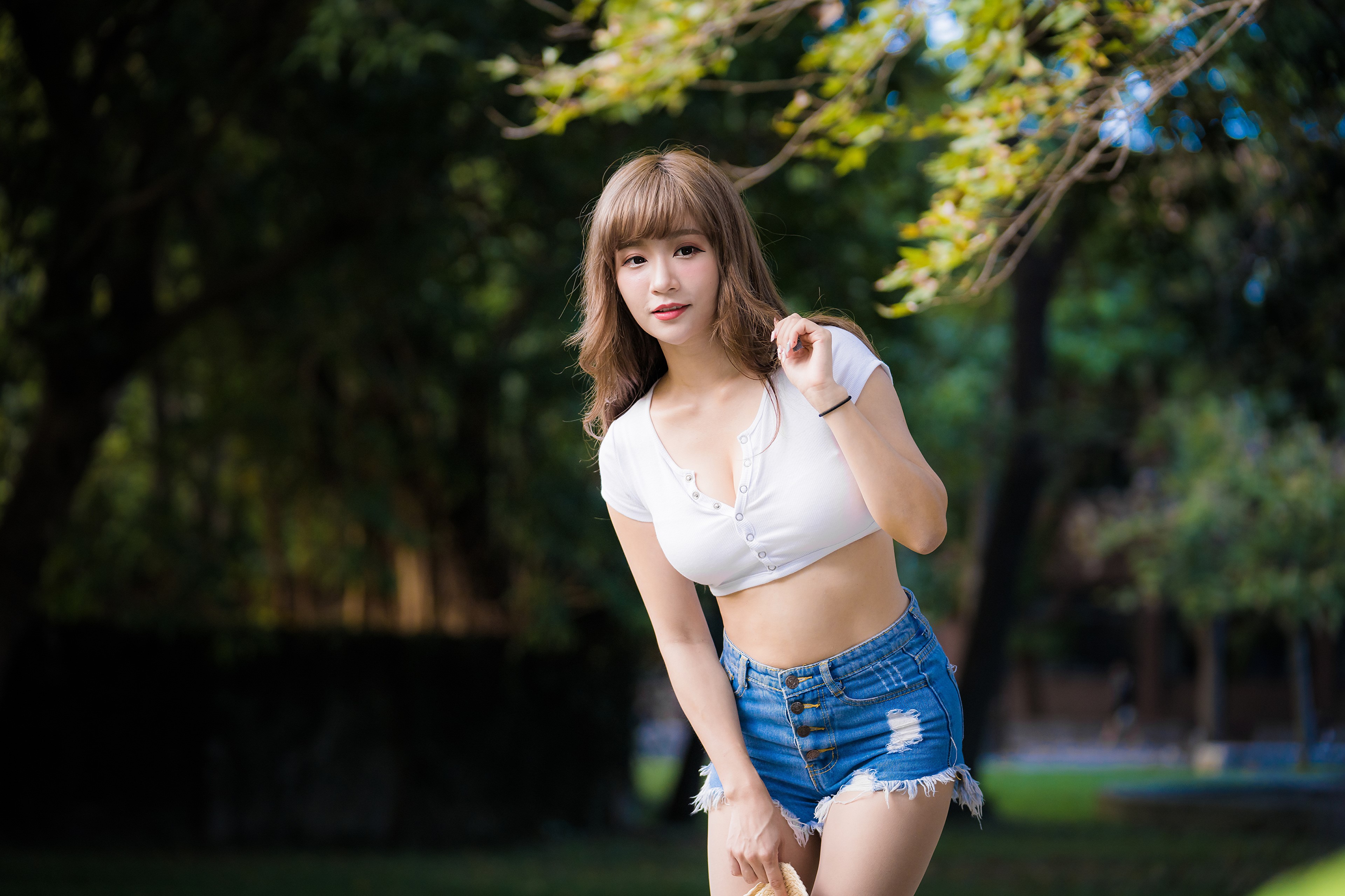 Asian woman in shorts posing outdoors HD Wallpaper