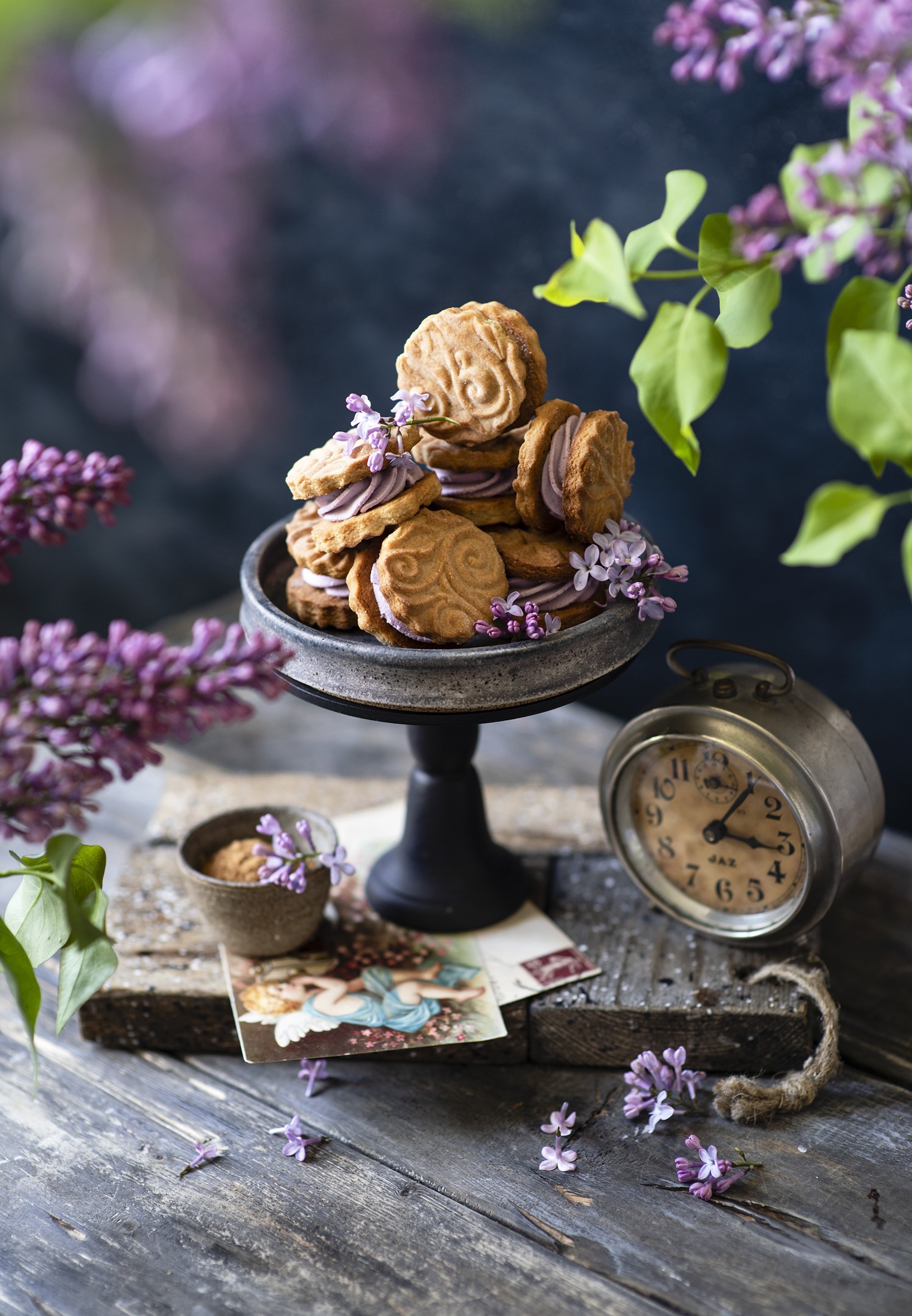 Cookies with lilac cream on a cake stand with a clock HD Phone Wallpaper