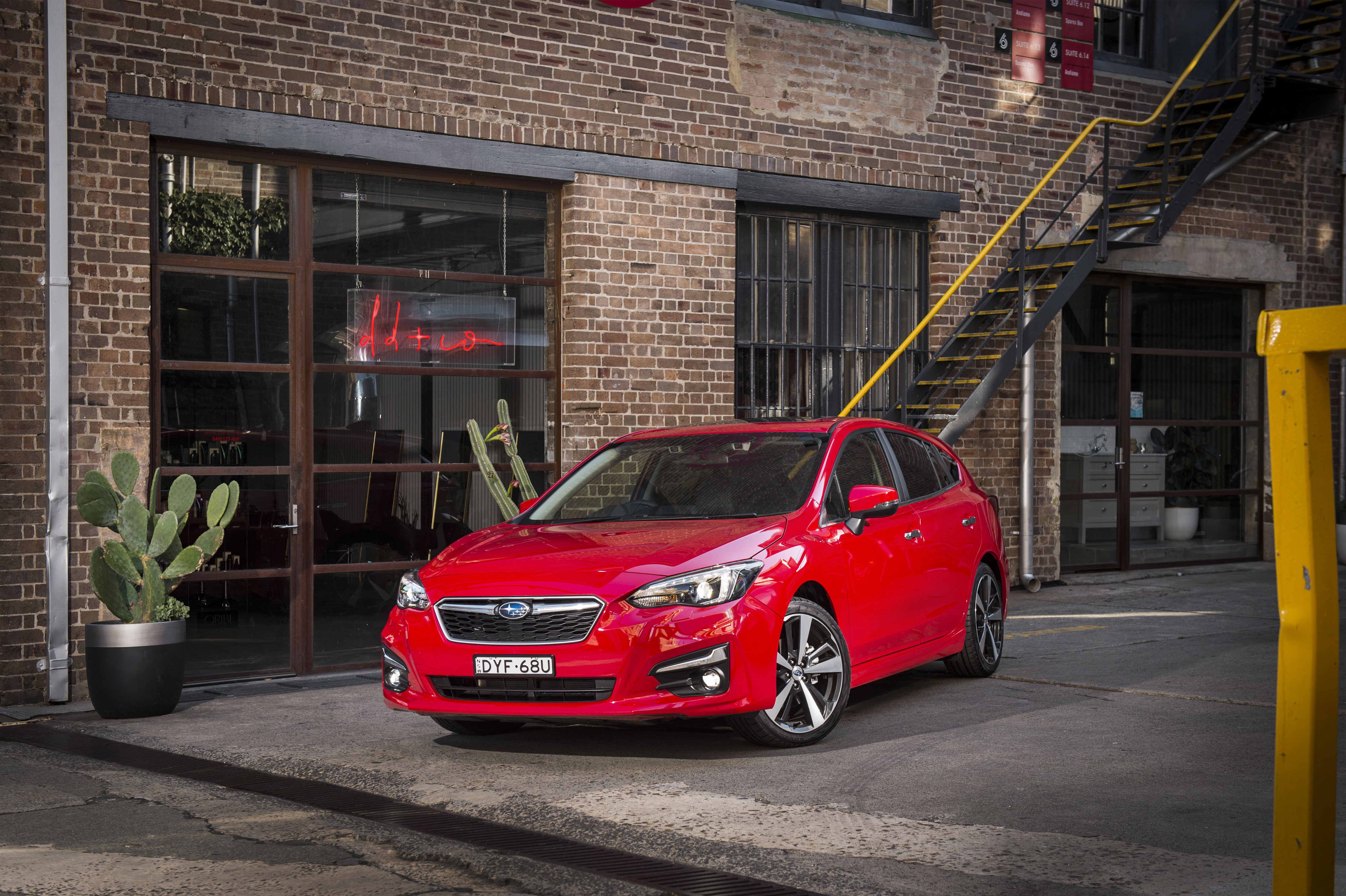 Red Subaru Impreza 5-door 2.0i S parked outdoors HD Wallpaper