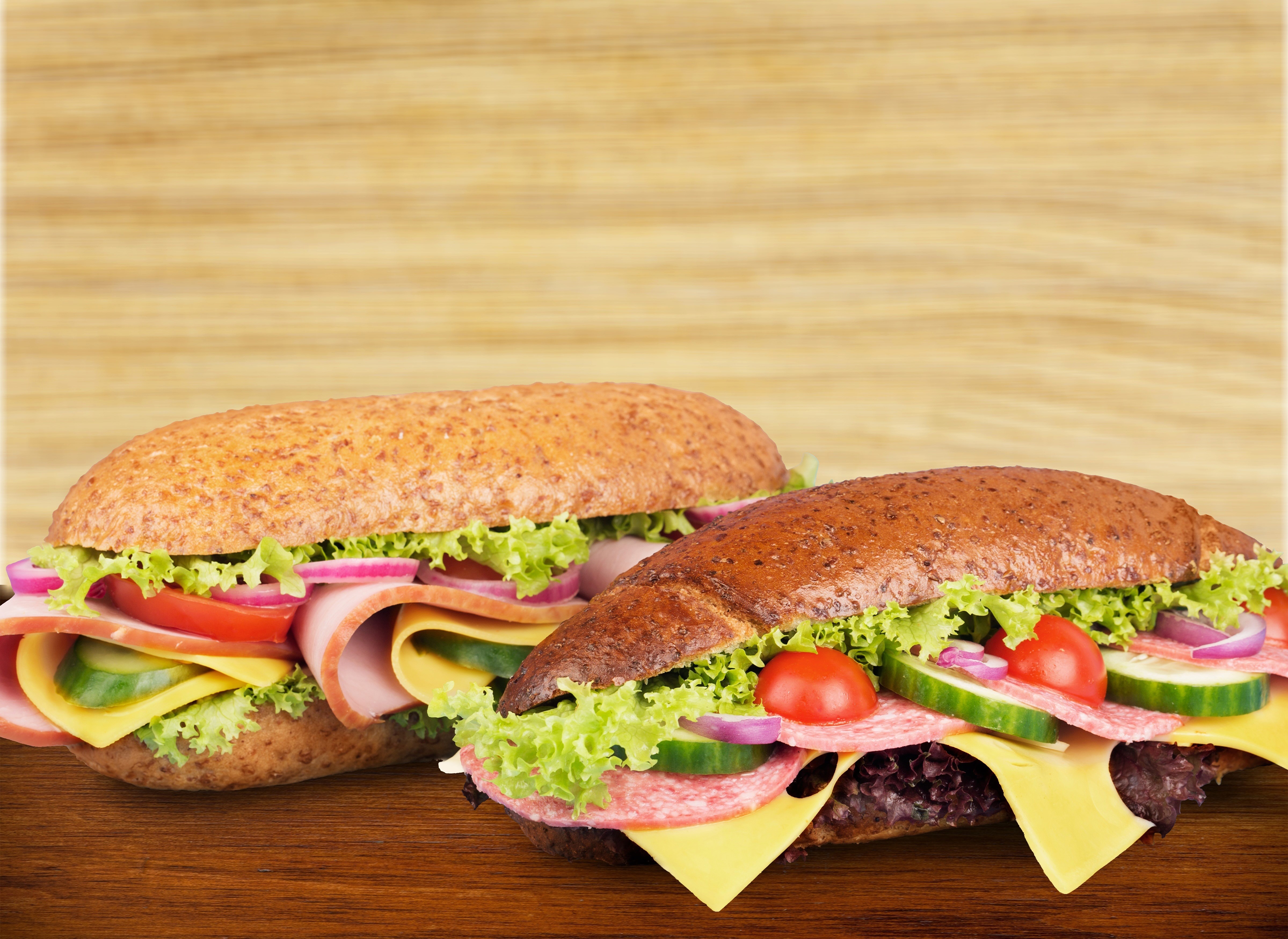 Two sandwiches with vegetables and sausage HD Wallpaper