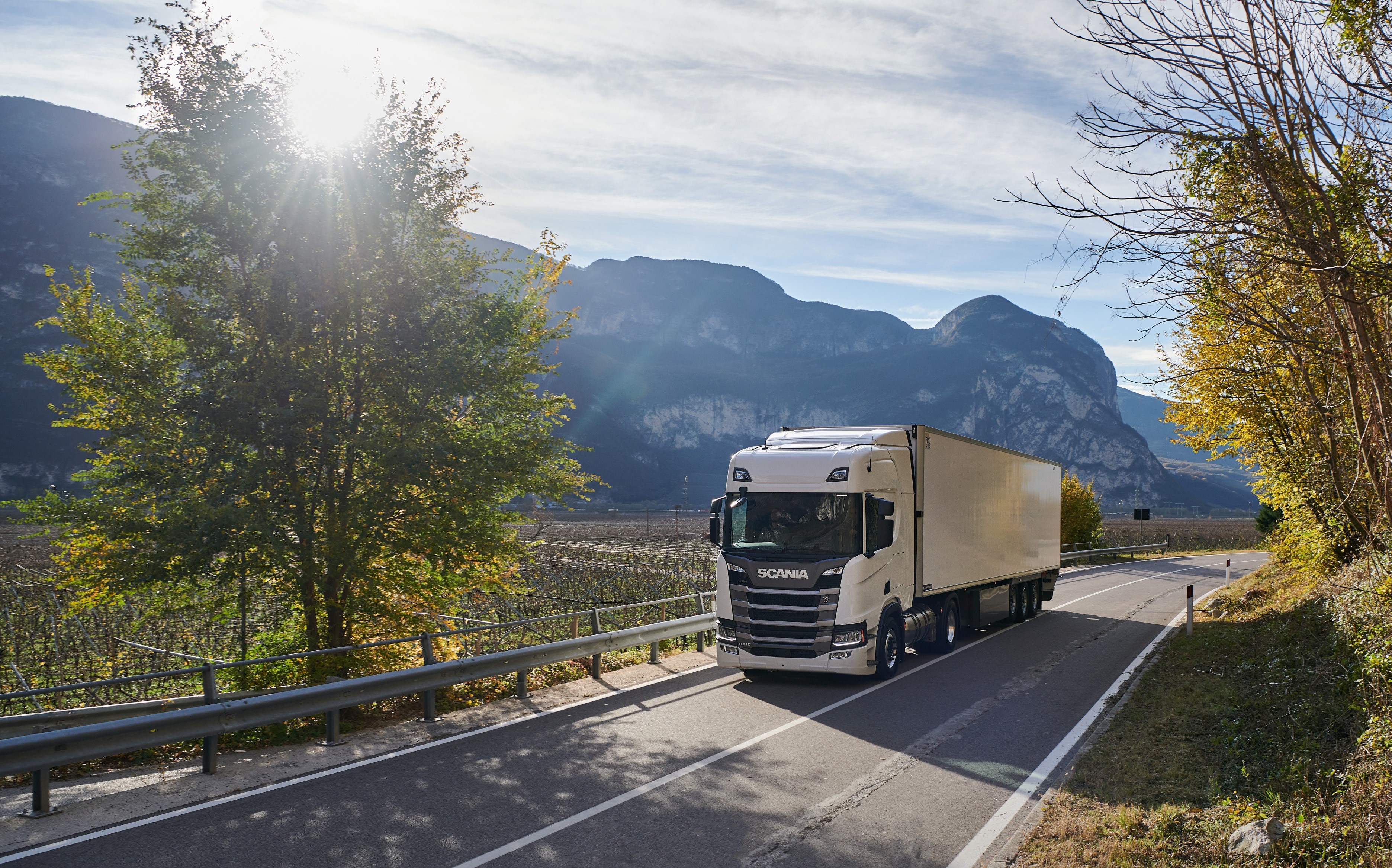 Scania R410 truck driving on a mountain road HD Wallpaper