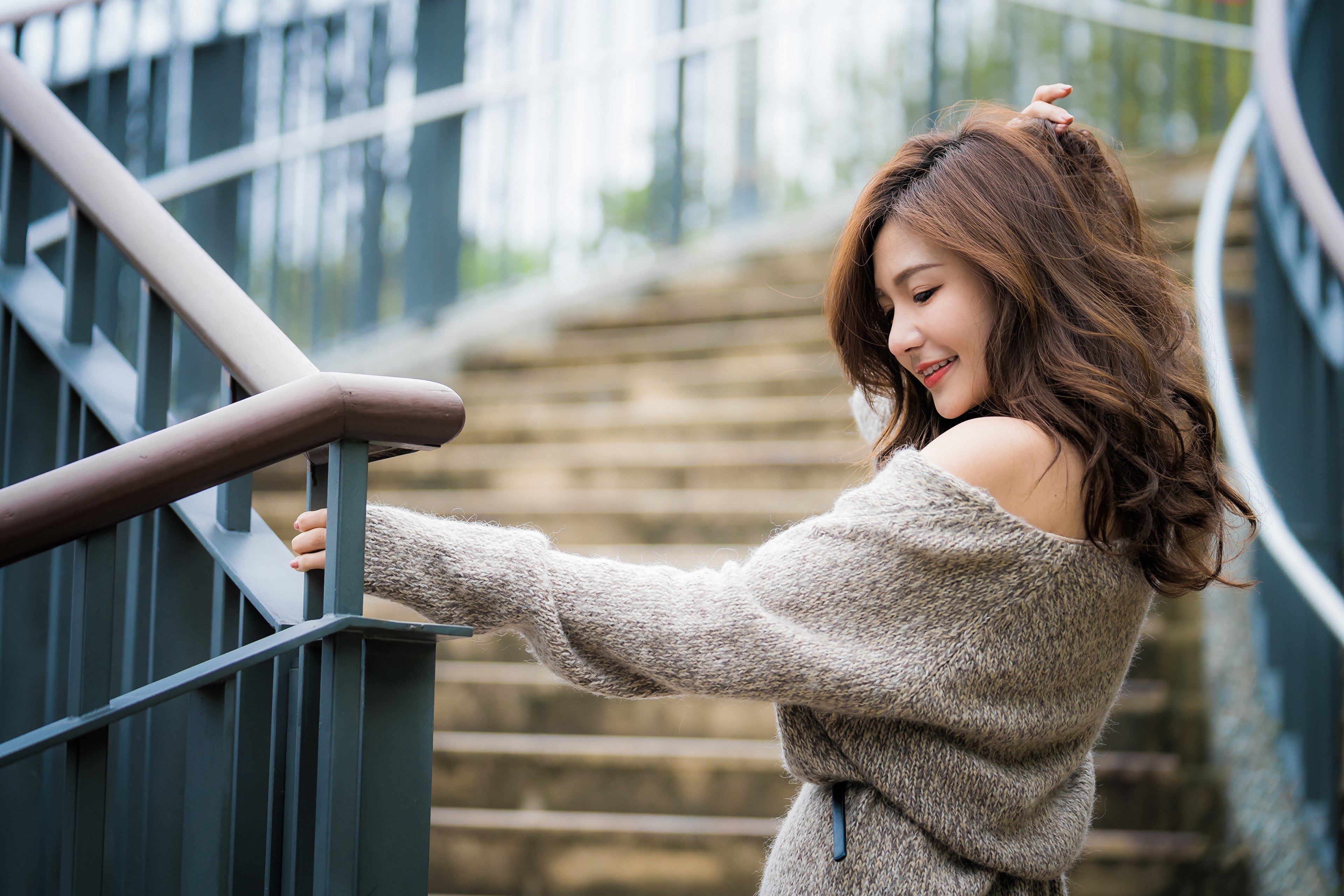 Brown-haired woman in sweater on stairs HD Wallpaper
