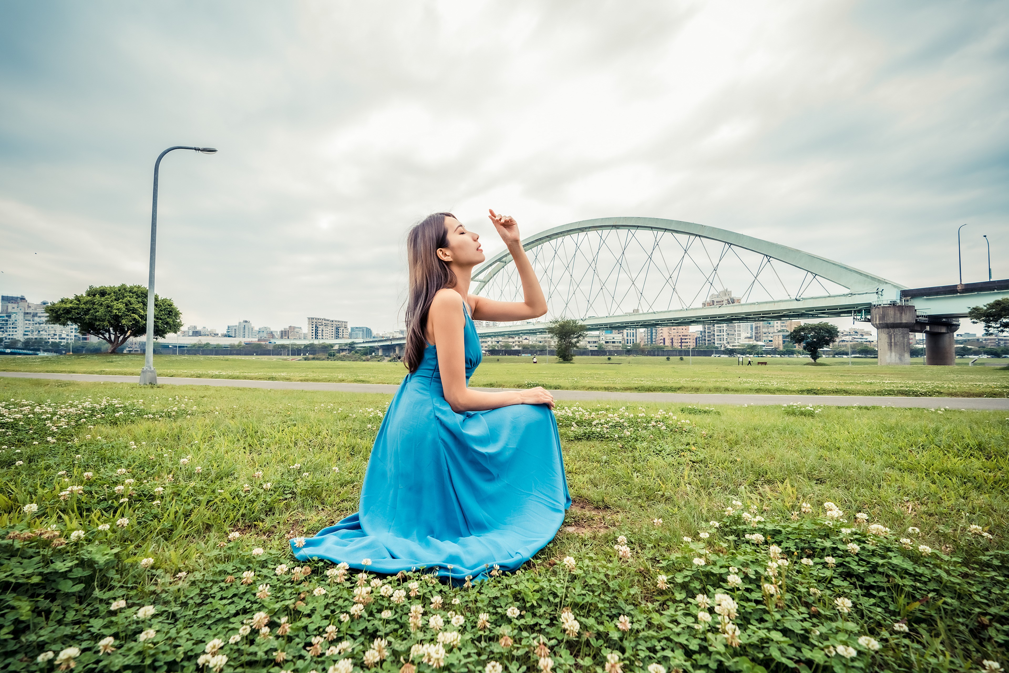 Asian woman in blue dress posing in grass HD Wallpaper