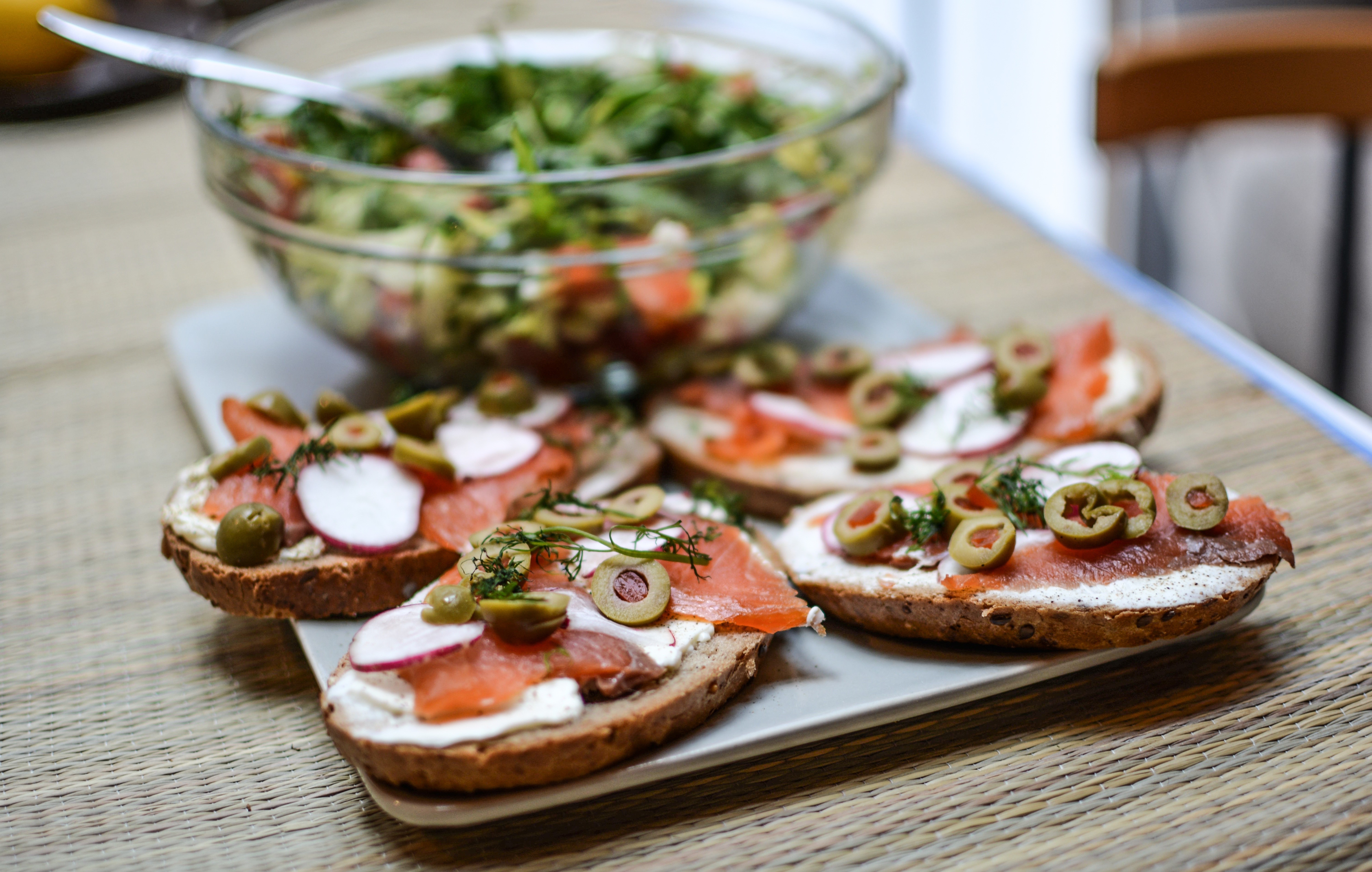 Smoked salmon open-faced sandwiches with olives and radishes HD Wallpaper