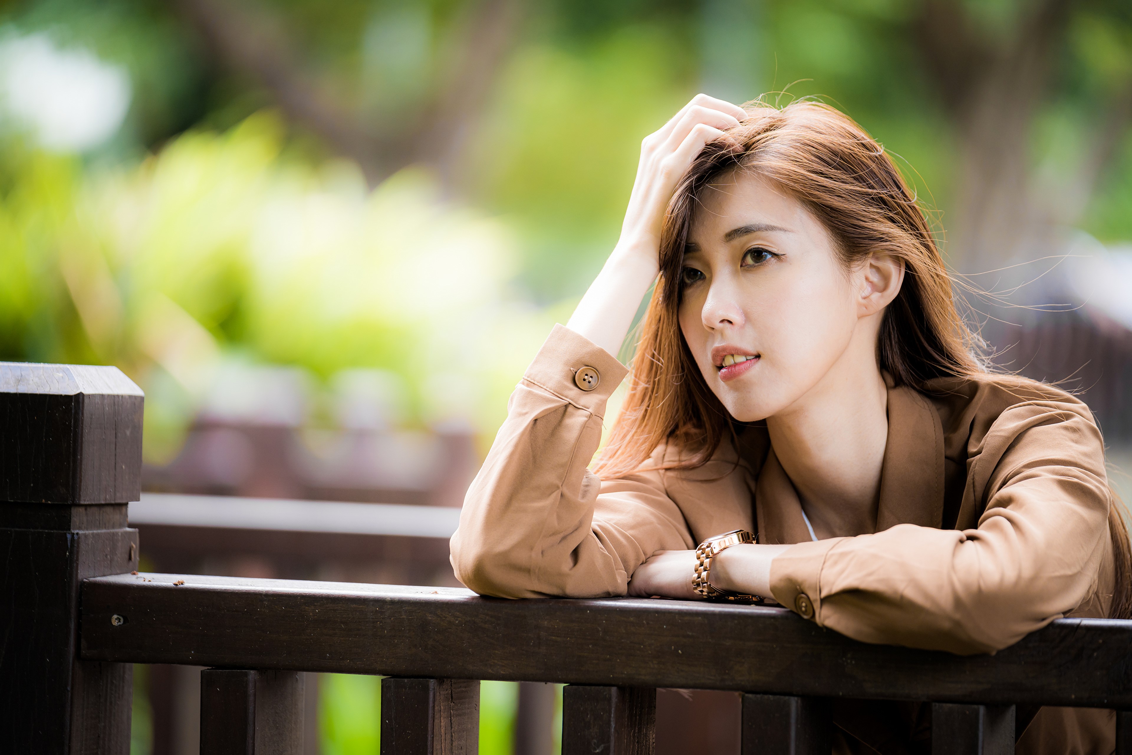4K Asian Woman with Flowing Hair and Thoughtful Glance HD Wallpaper