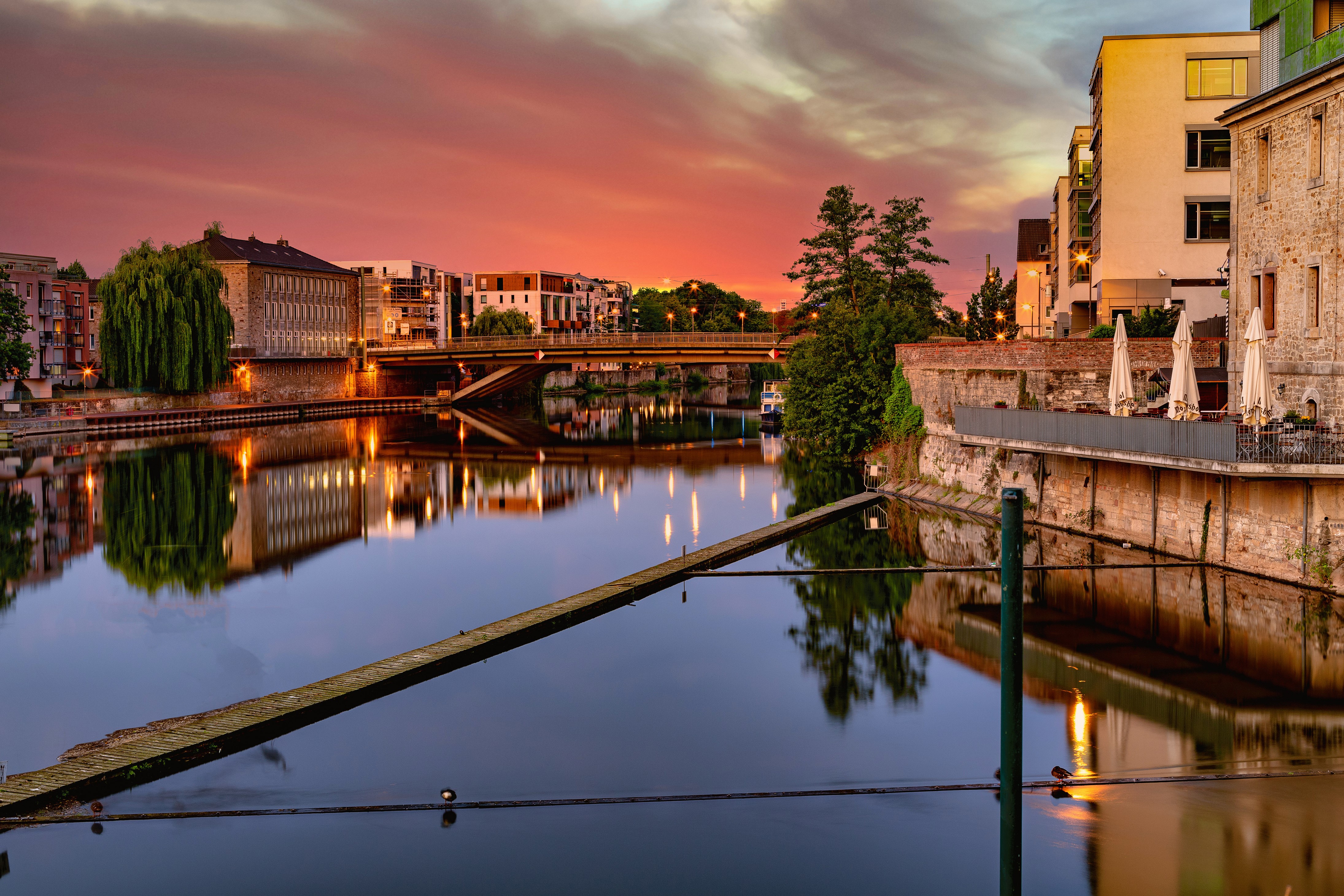 Kassel, Germany at sunset with river and bridge HD Wallpaper