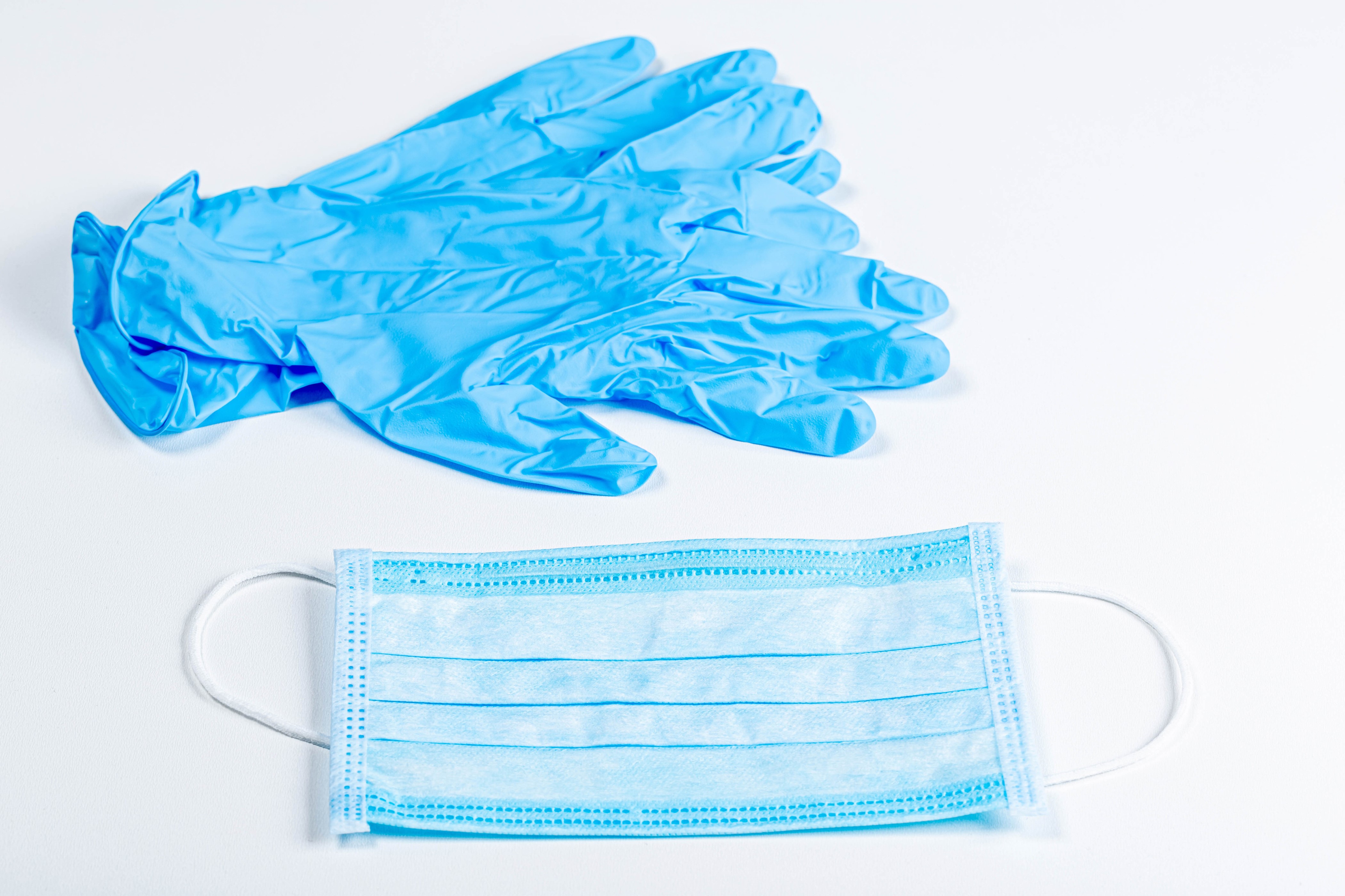 Blue medical gloves and face mask on white background HD Wallpaper