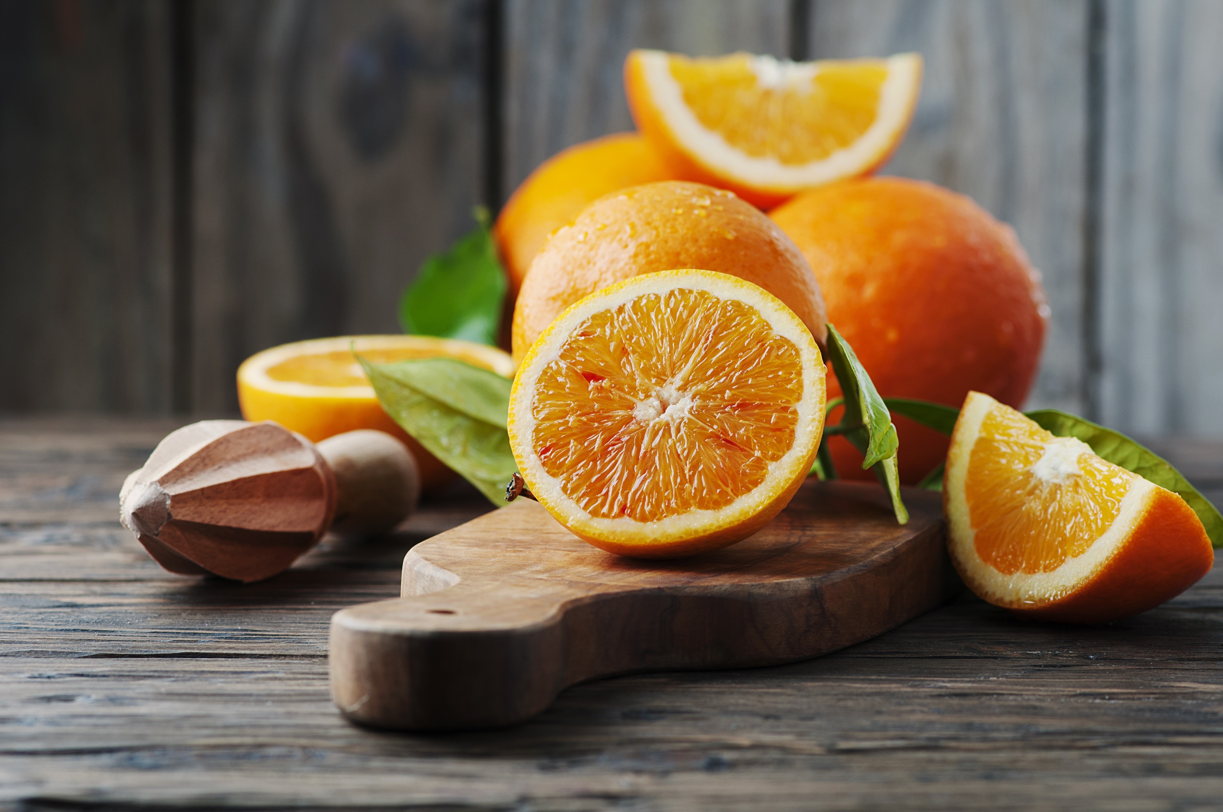 Oranges on a wooden table with a juicer HD Wallpaper