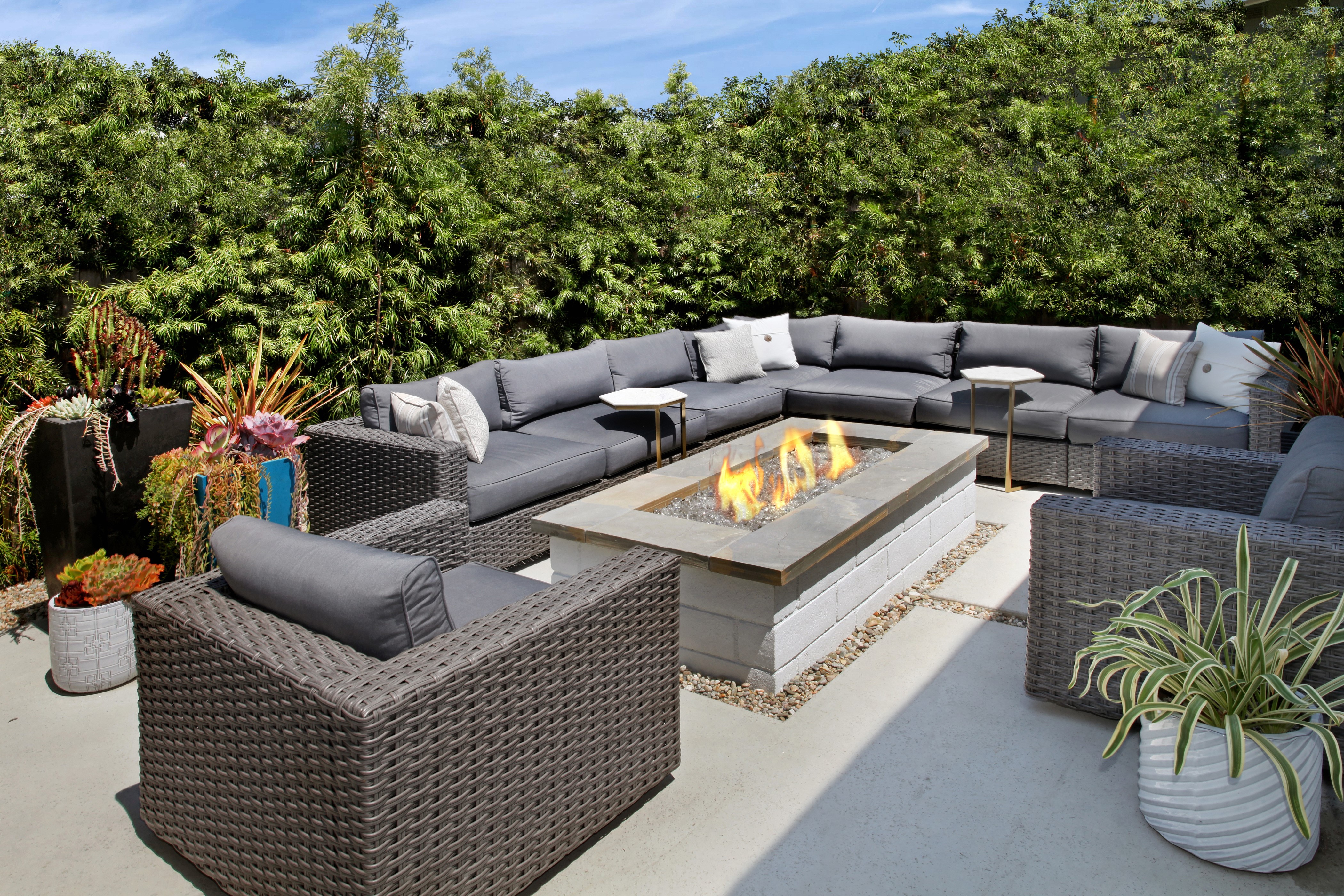 Outdoor living space with sectional sofa and fire pit HD Wallpaper