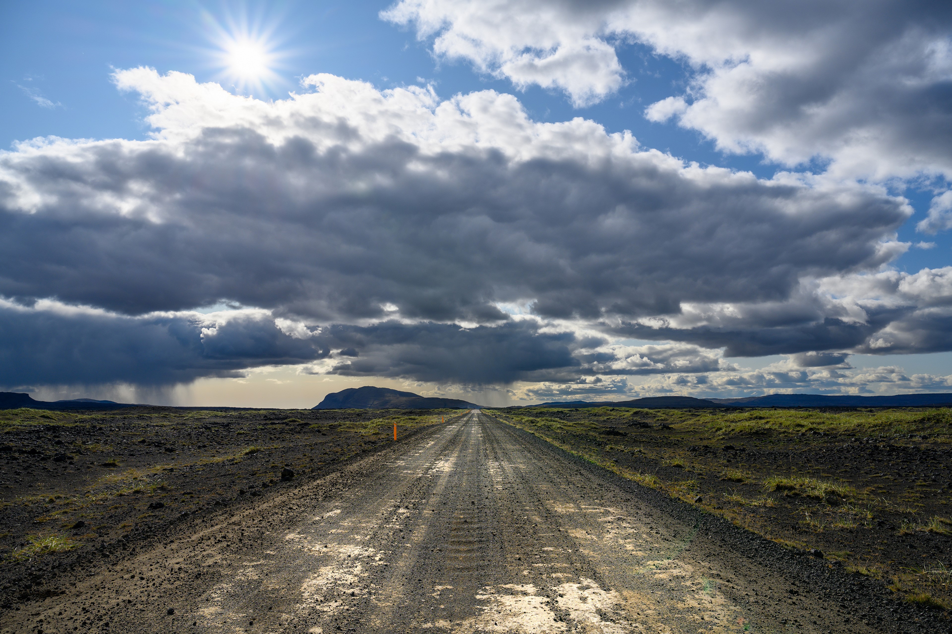 Road through Iceland under dramatic clouds HD Wallpaper