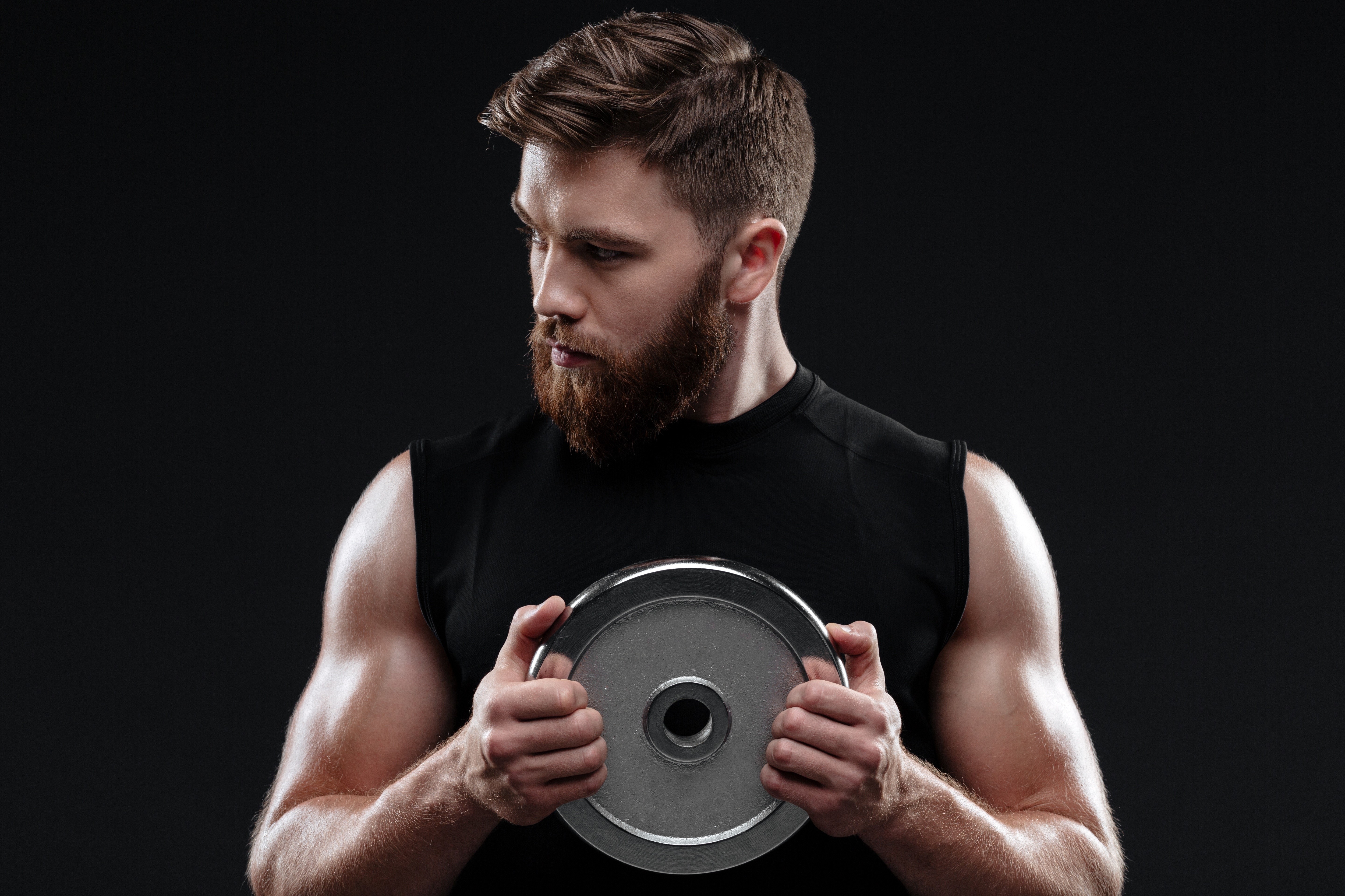 Man with beard holding weight plate HD Wallpaper
