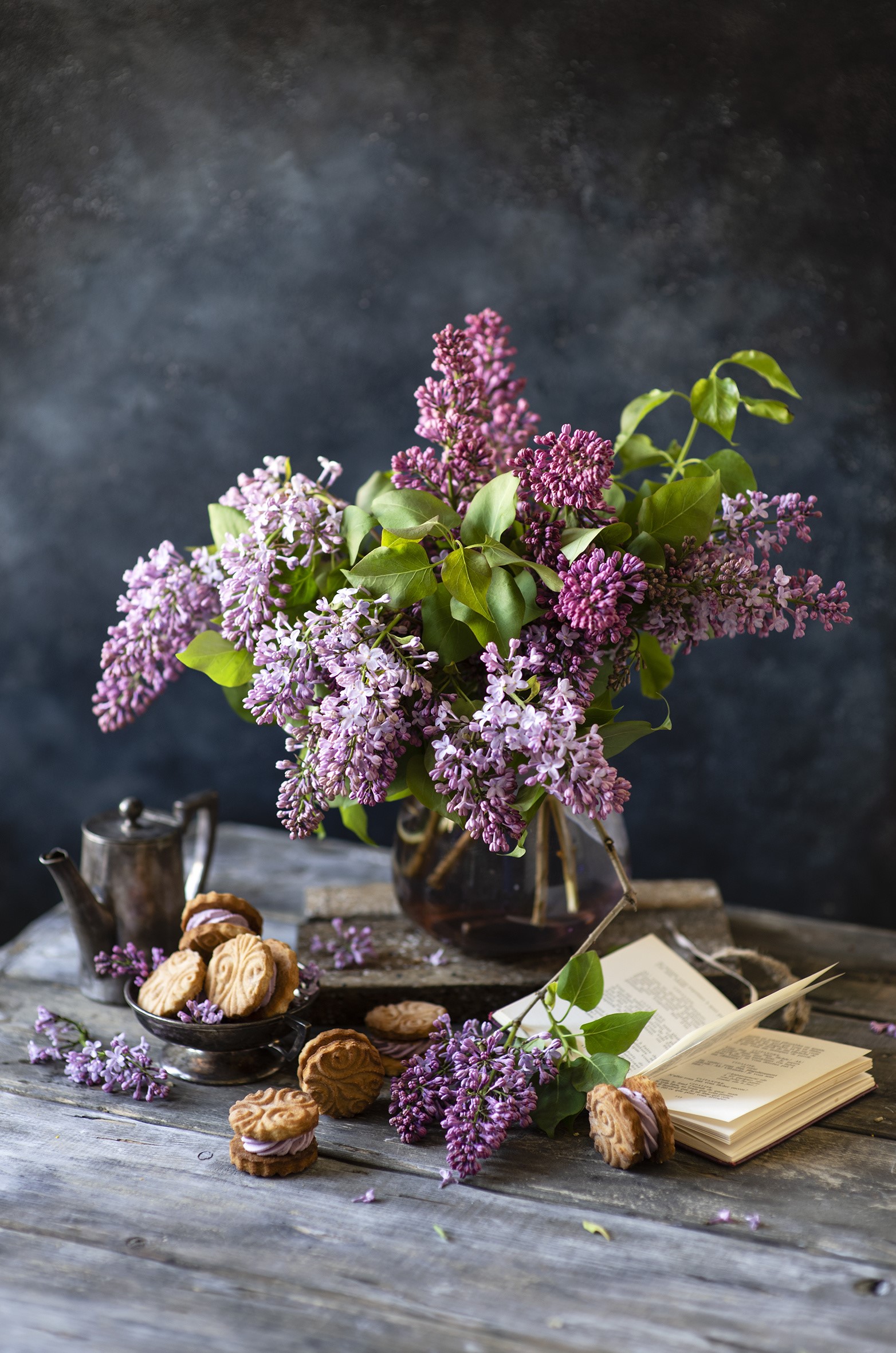 Still-life of lilac flowers, cookies, and a book HD Phone Wallpaper