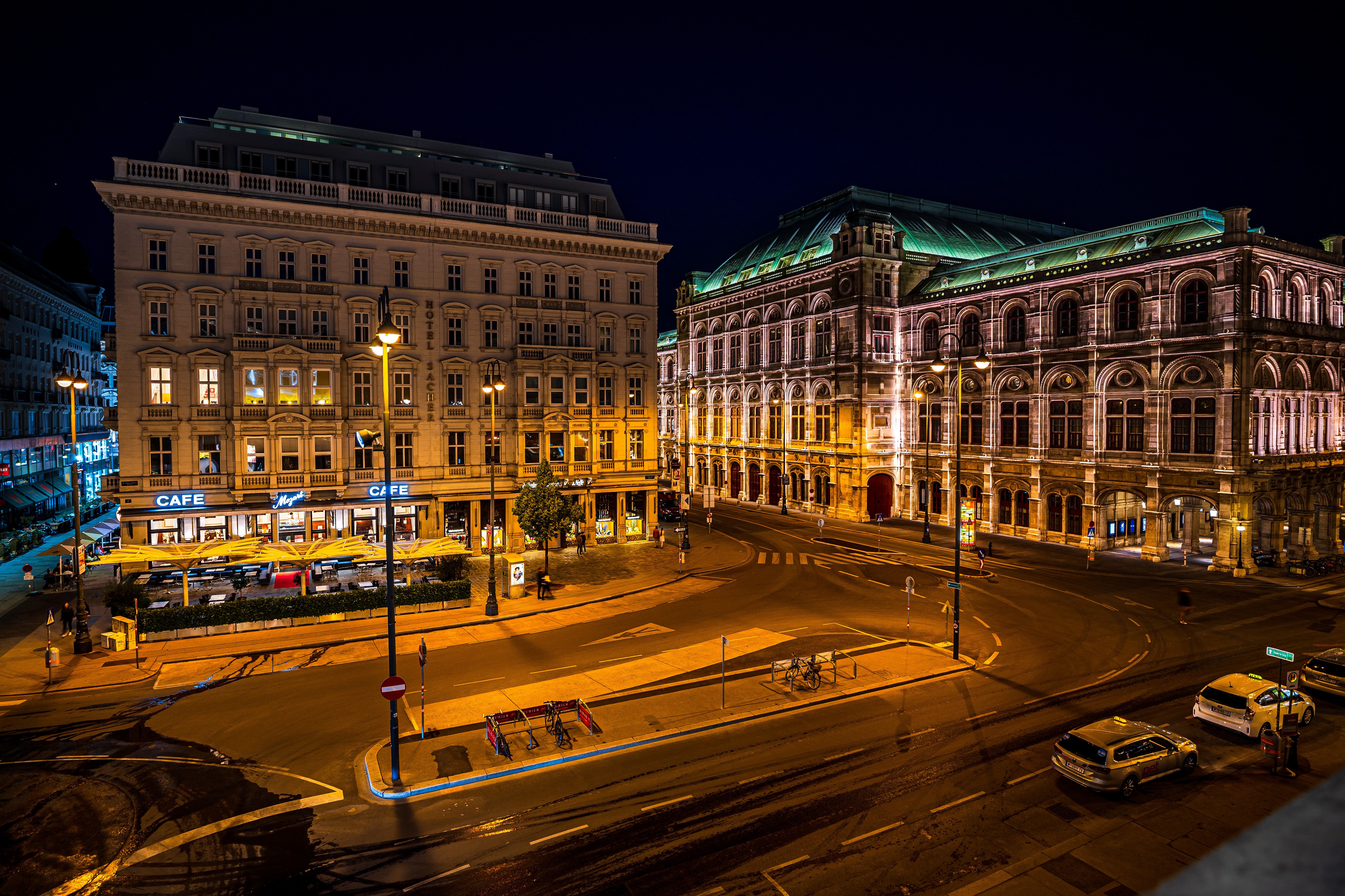 Vienna street at night with buildings and cars HD Wallpaper