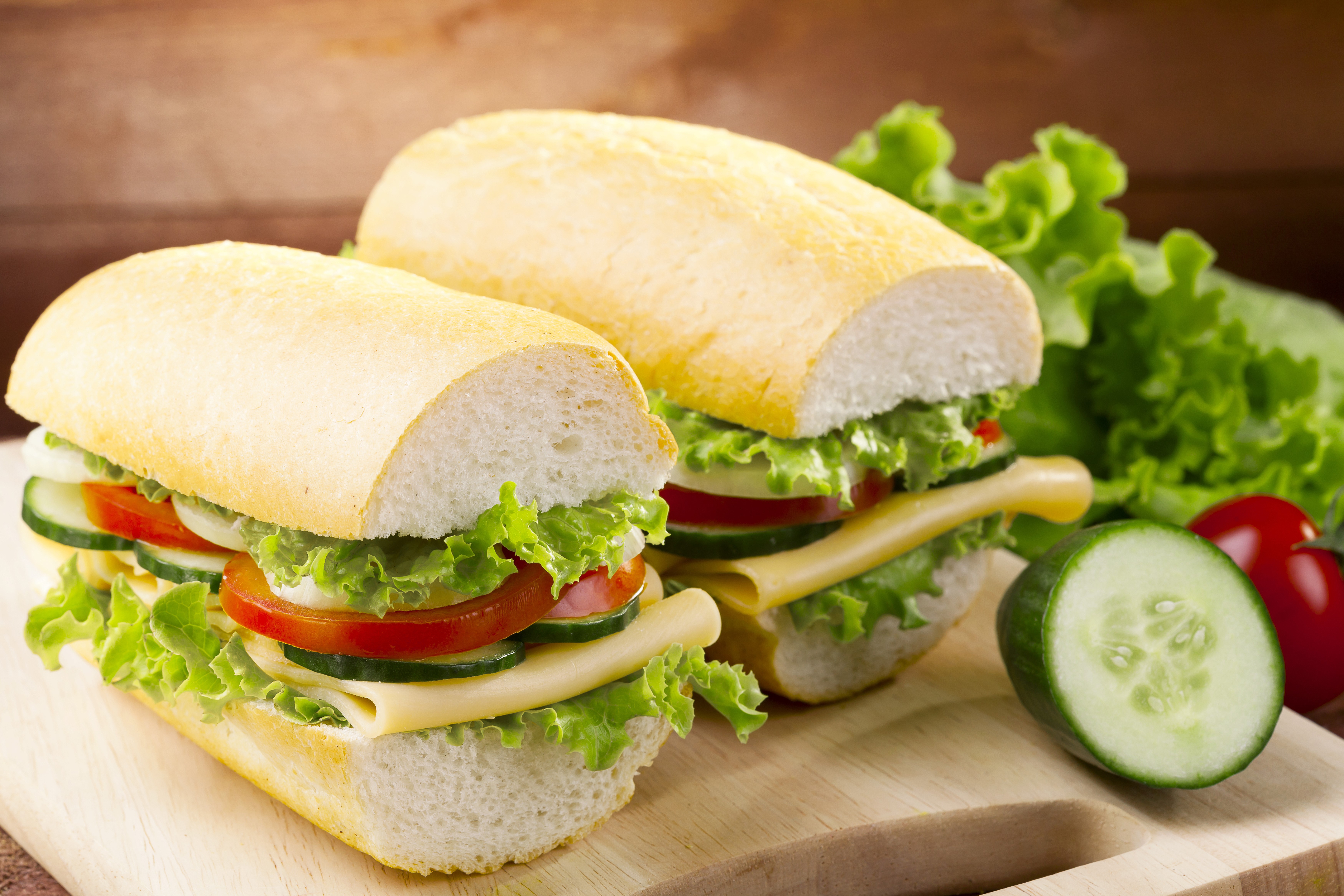 Two sandwiches with vegetables and cheese HD Wallpaper