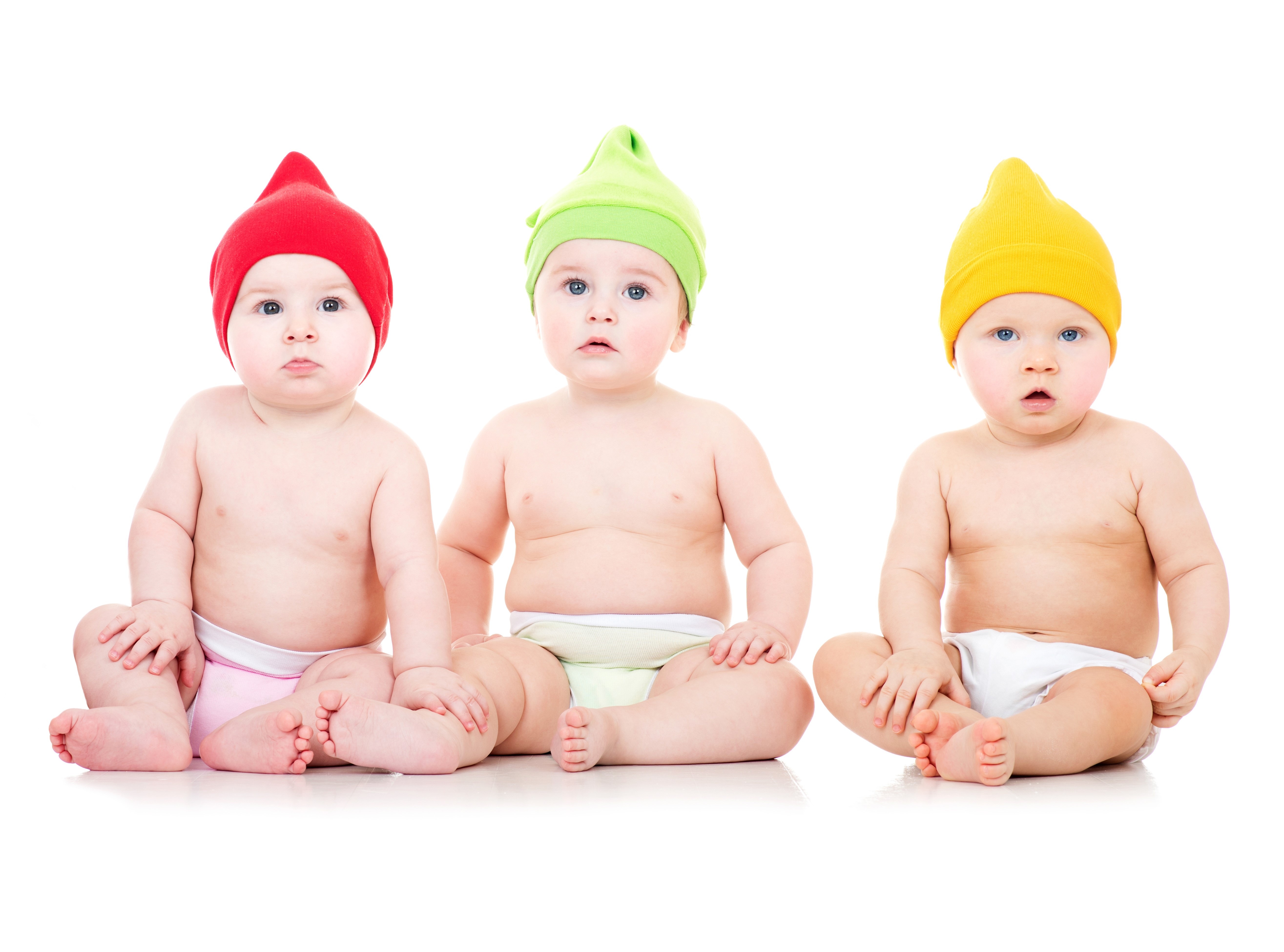 Three babies in colorful hats sitting on white background HD Wallpaper