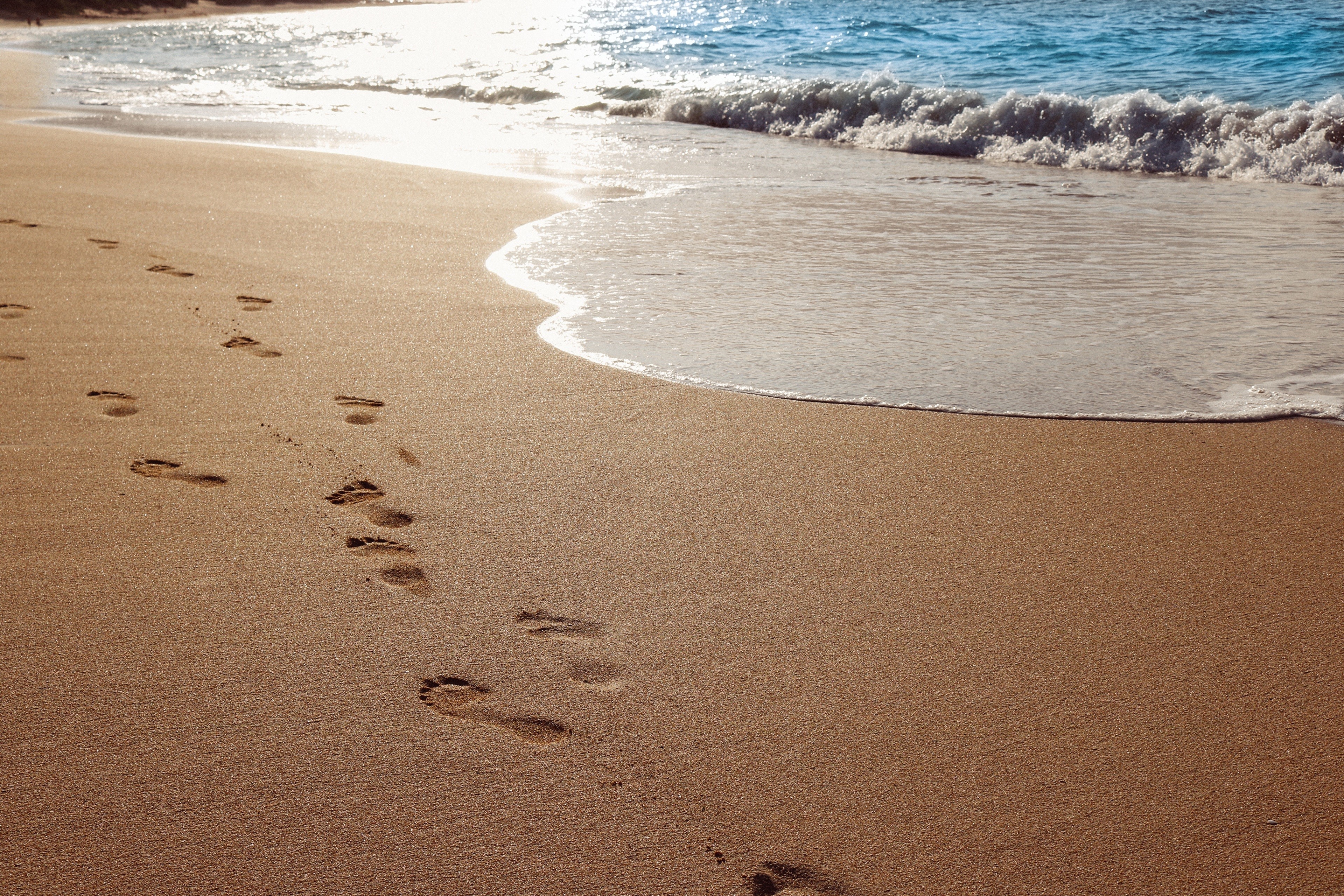 Footprints on a Sandy Beach with Waves HD Wallpaper