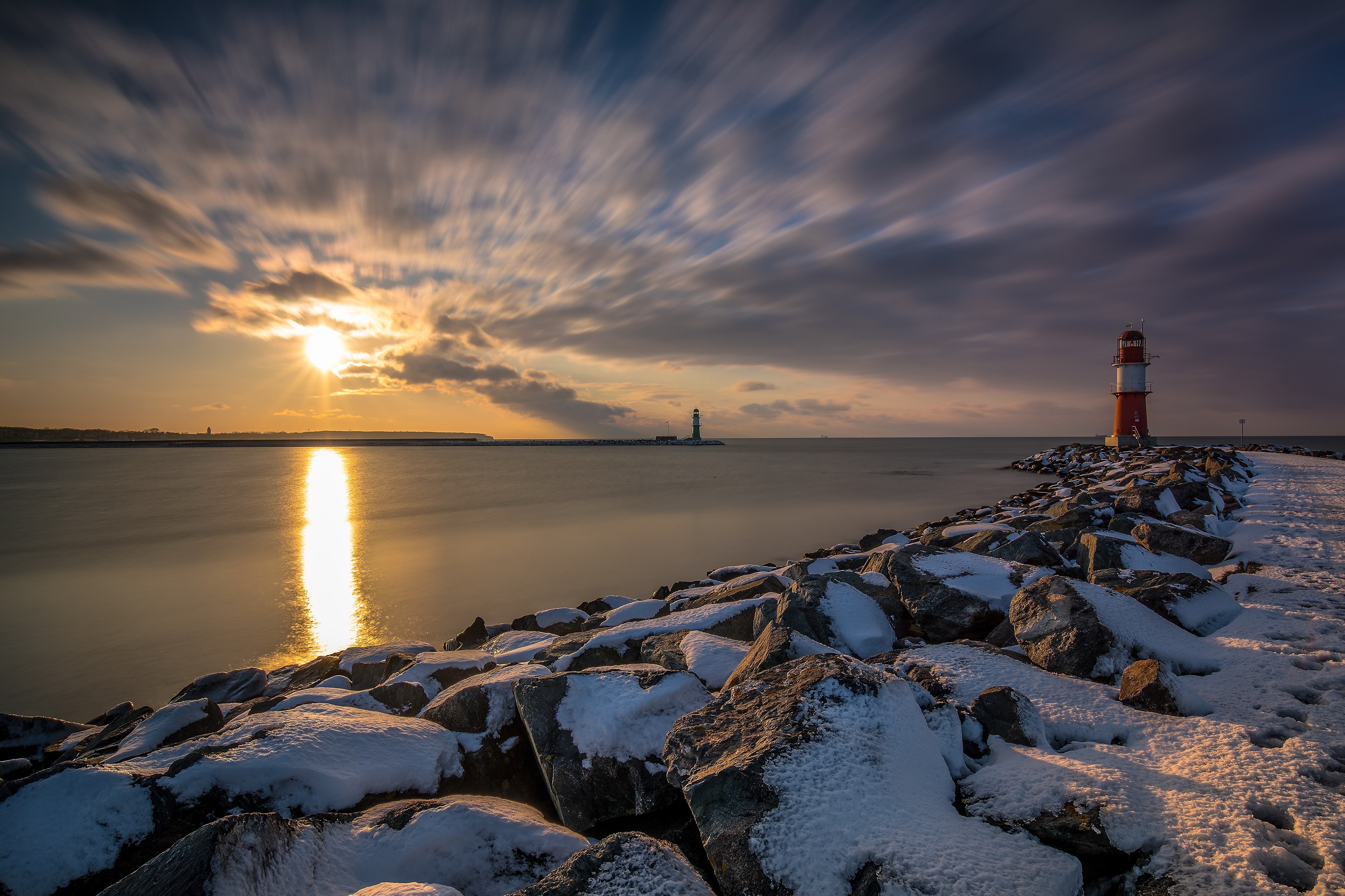 Lighthouse on a rocky coast at sunset, Germany HD Wallpaper