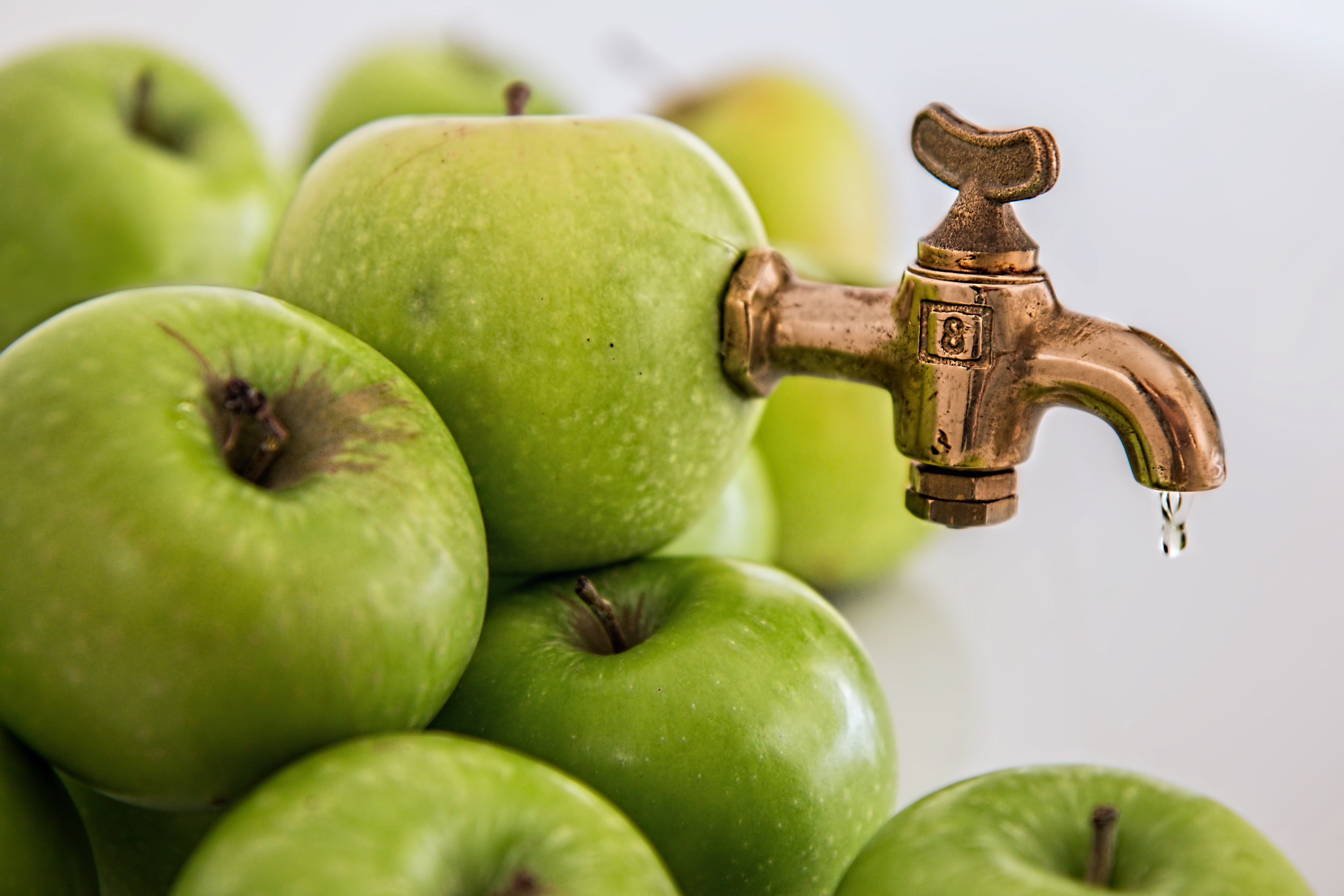 Green apples with a brass tap HD Wallpaper