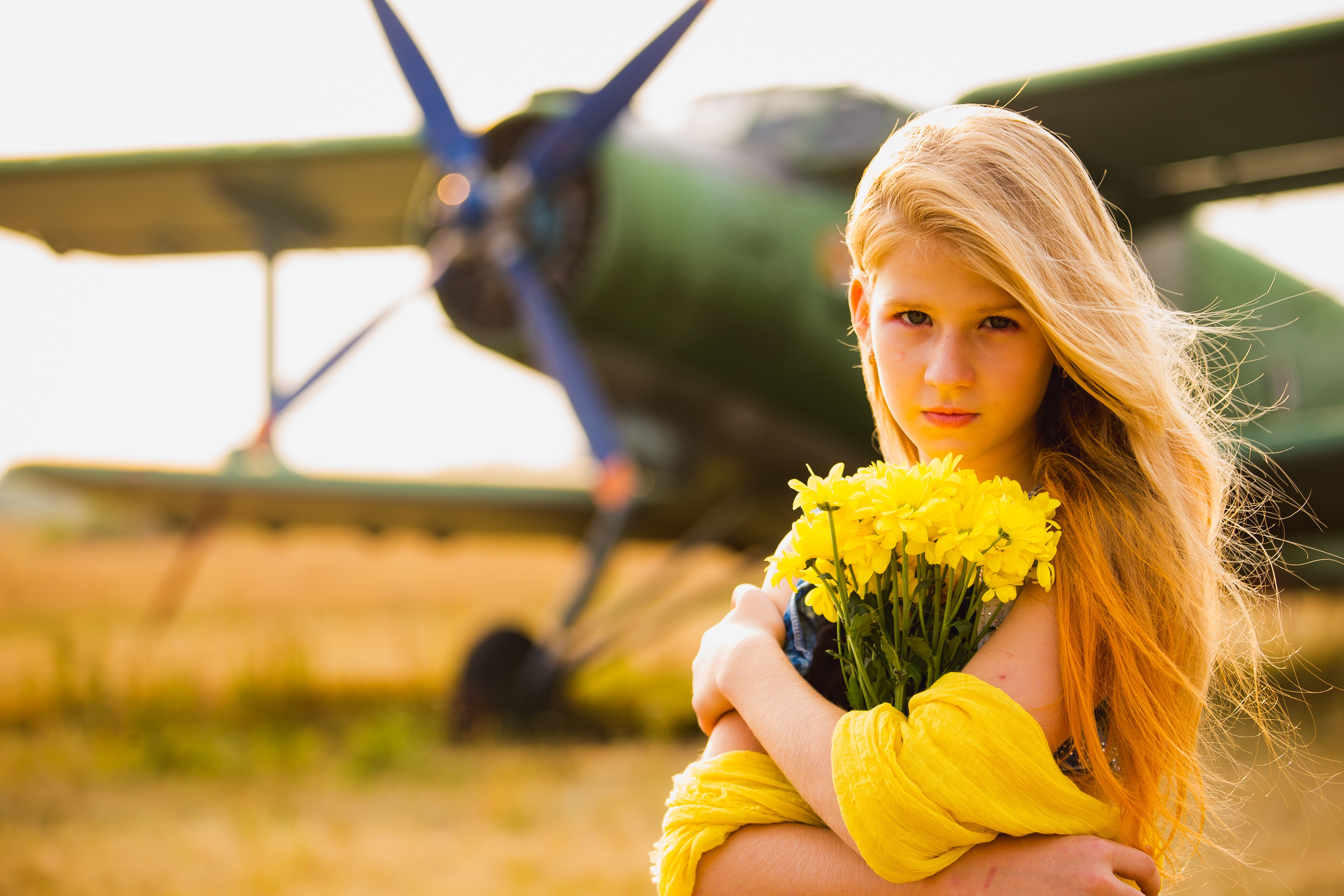 Blonde girl with yellow flowers and airplane HD Wallpaper