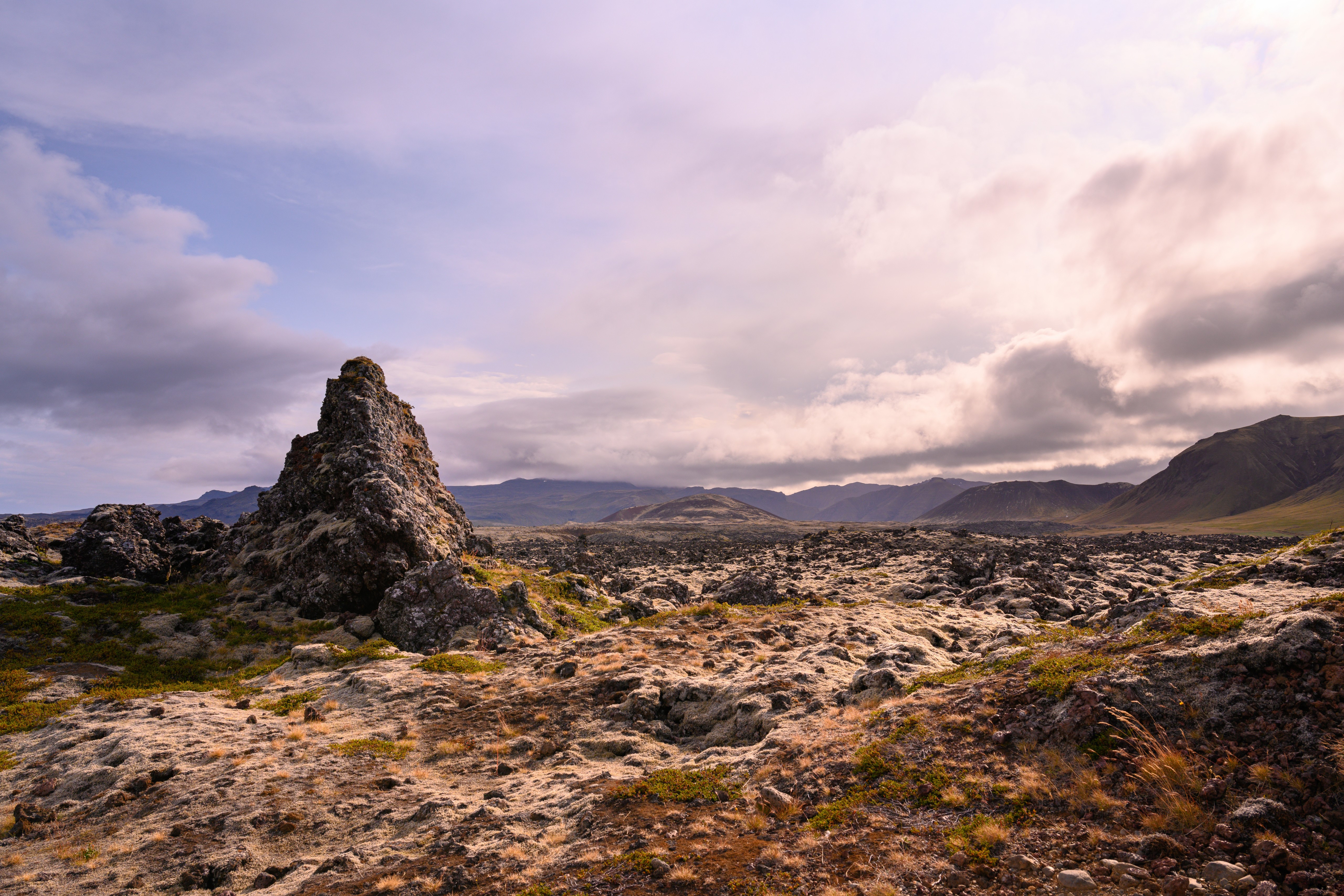 Icelandic Lava Field with Crag and Mountains HD Wallpaper
