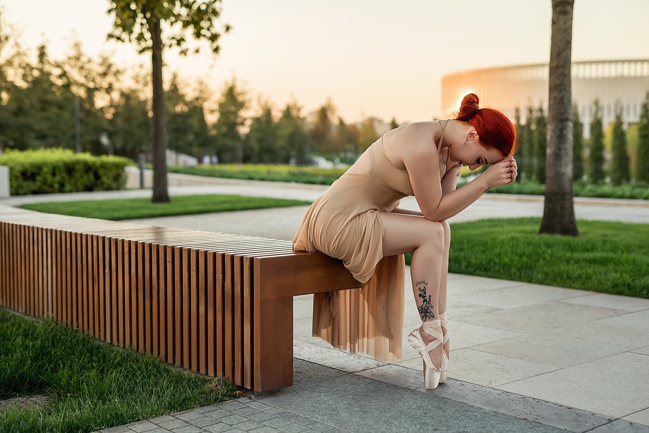 Redhead ballerina sitting on a bench in a park HD Wallpaper