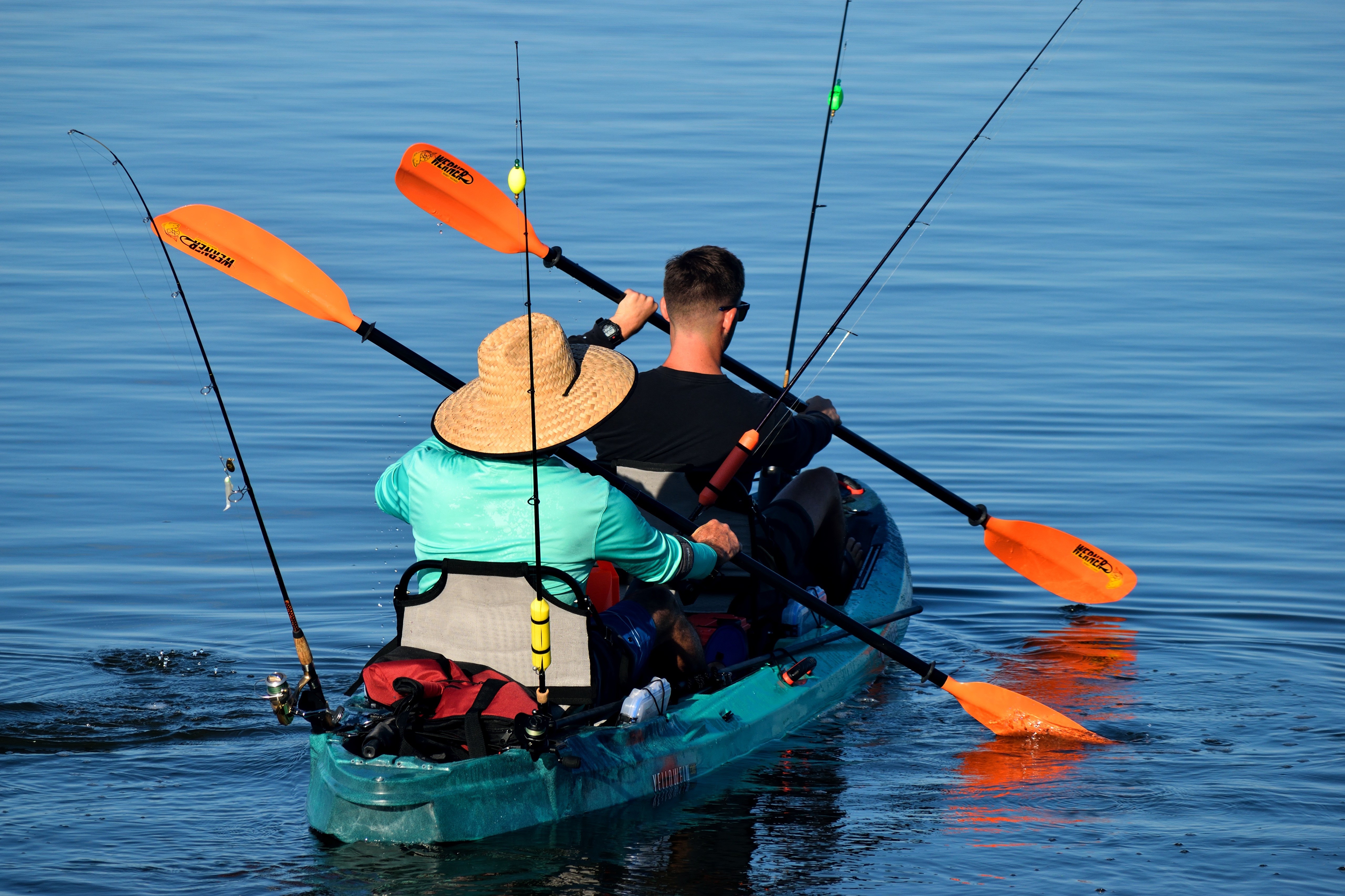 Two men fishing from a kayak HD Wallpaper