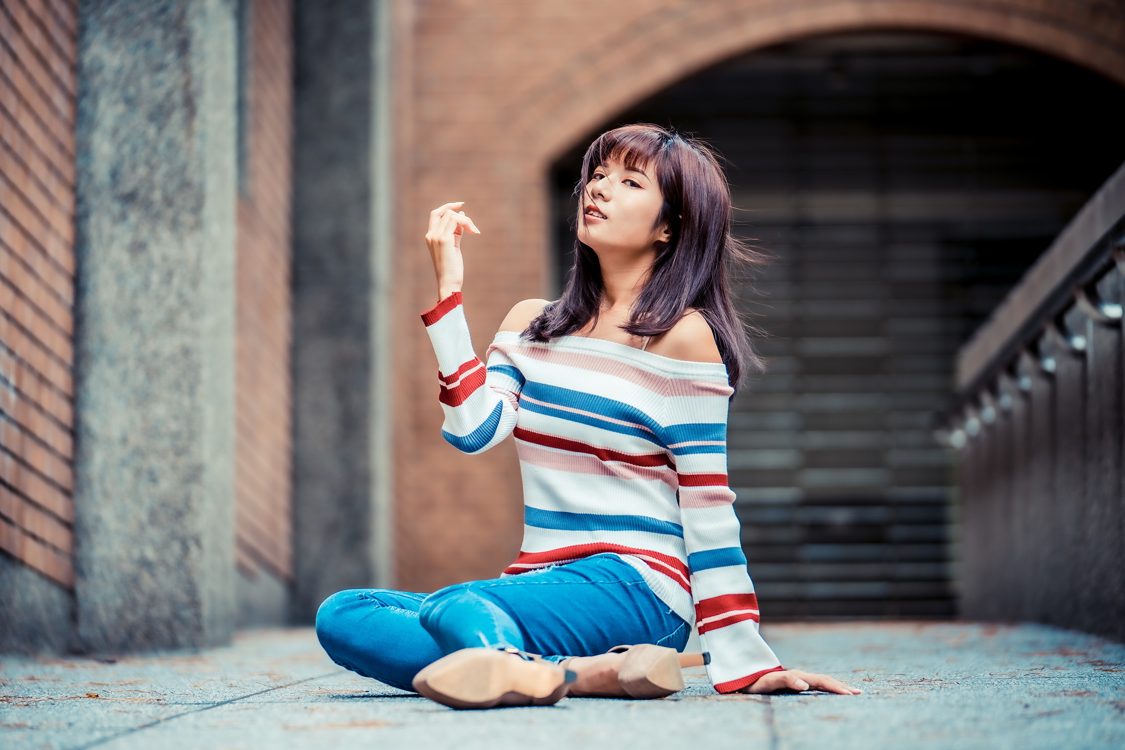 Asian woman sitting in jeans and sweater HD Wallpaper