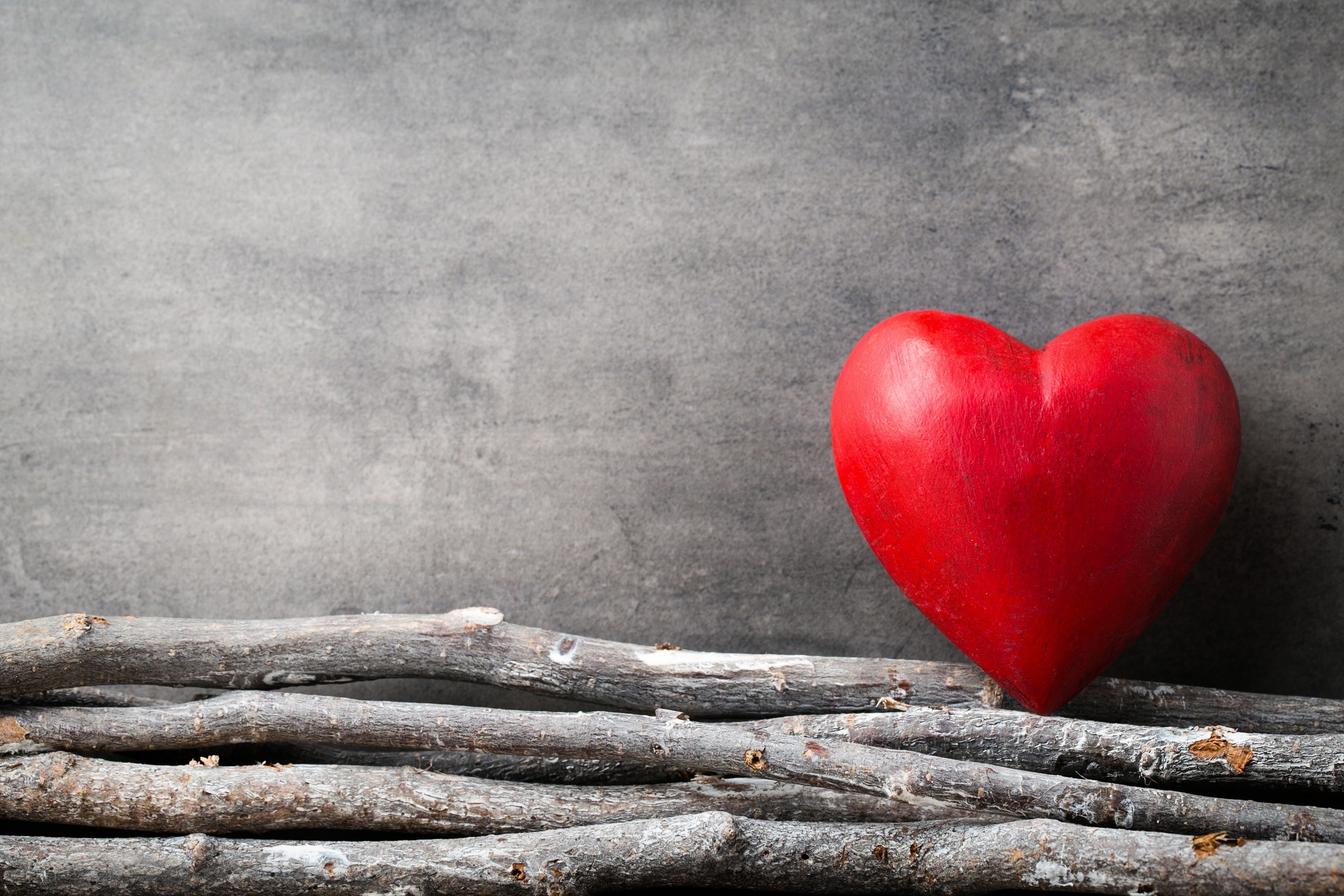 Red heart on a bed of sticks HD Wallpaper