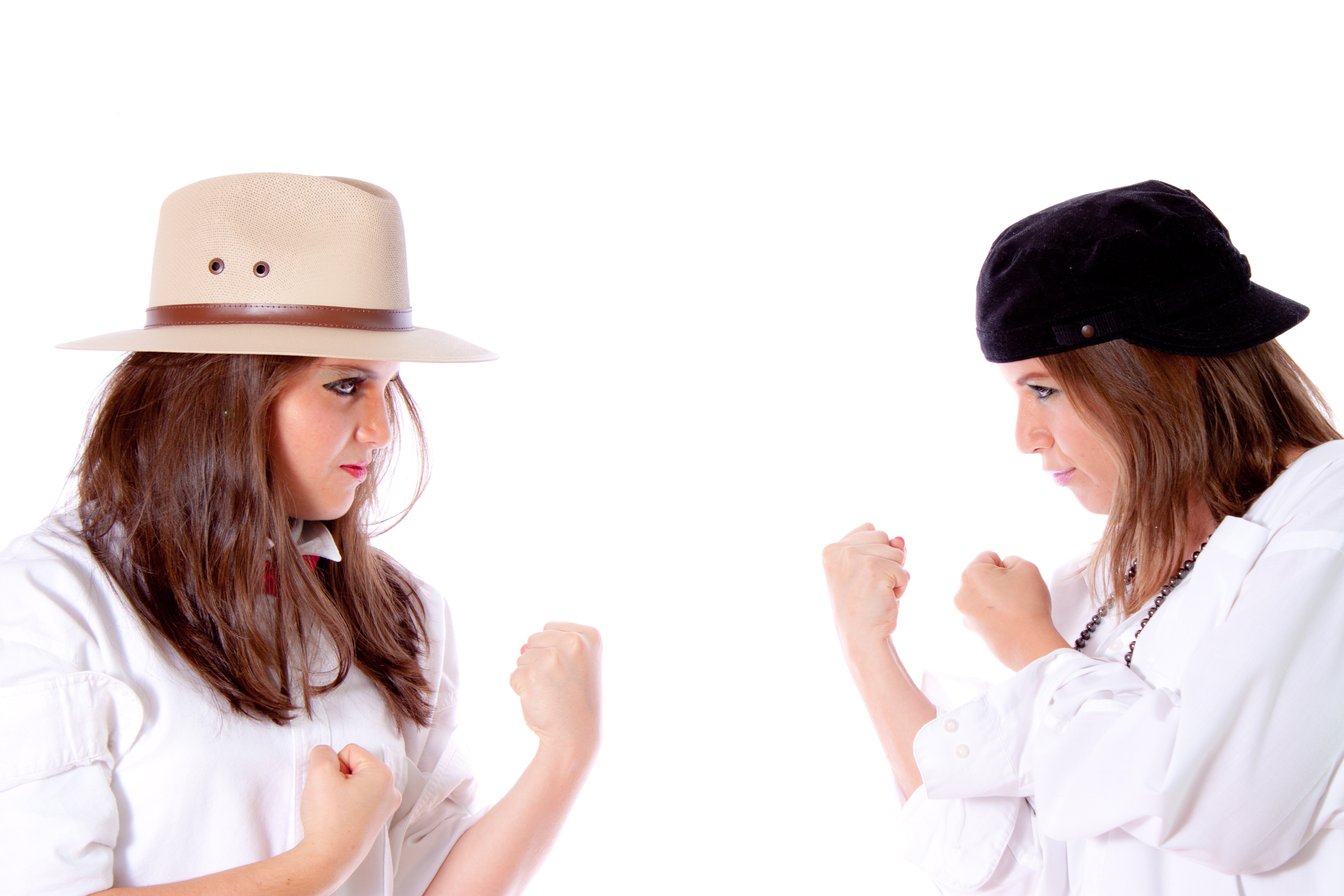 Two women in fighting poses on white background HD Wallpaper