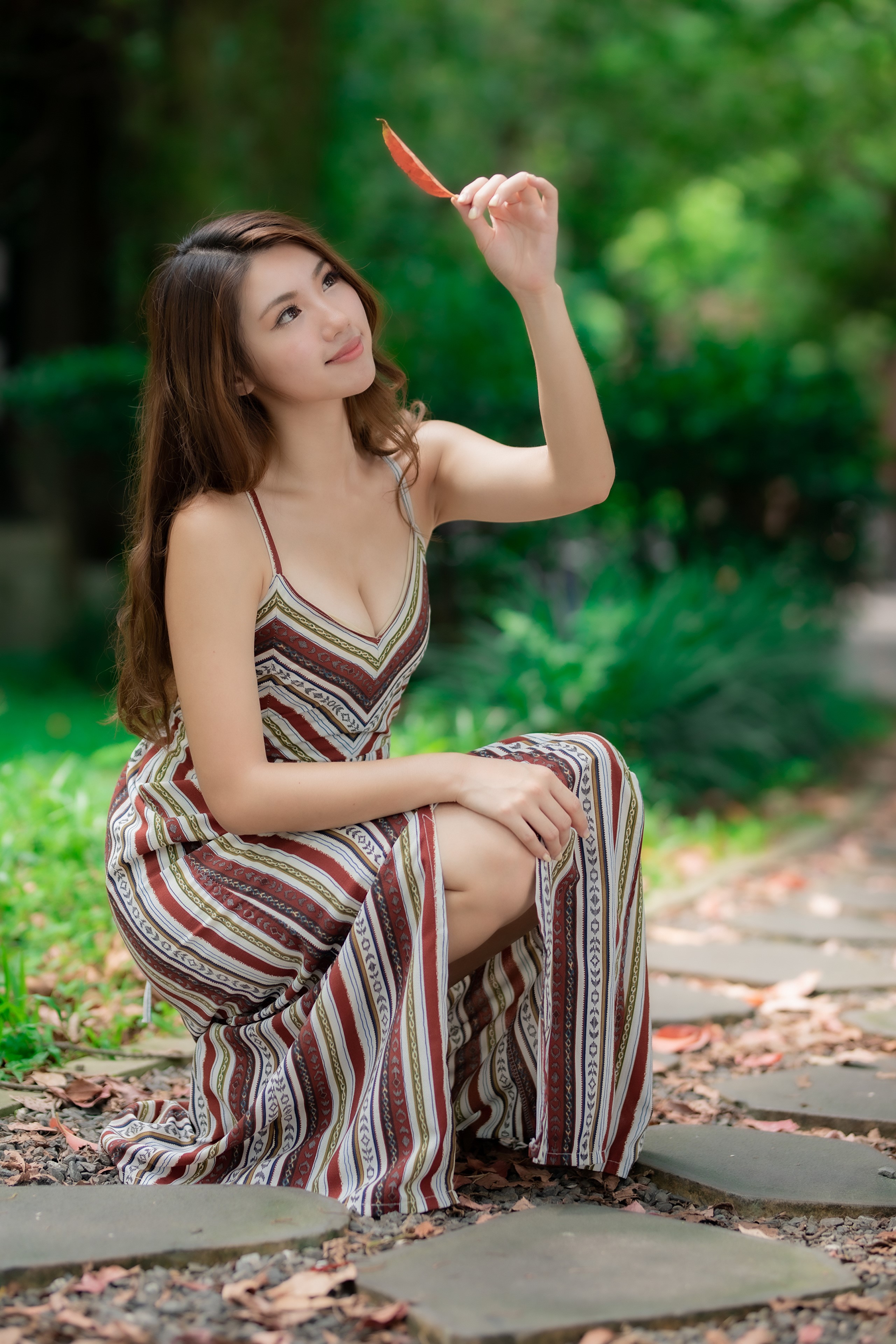 Asian woman in a dress holding a leaf HD Phone Wallpaper