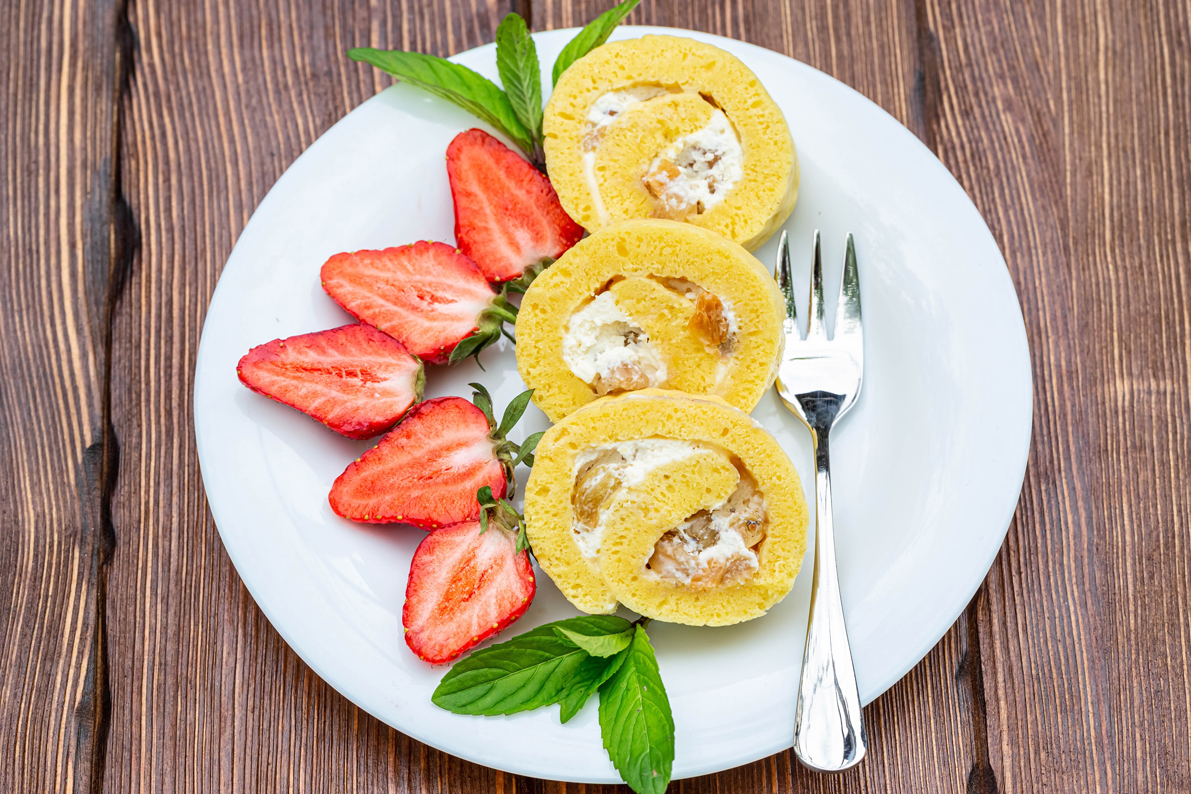 Swiss roll with strawberries on a plate HD Wallpaper