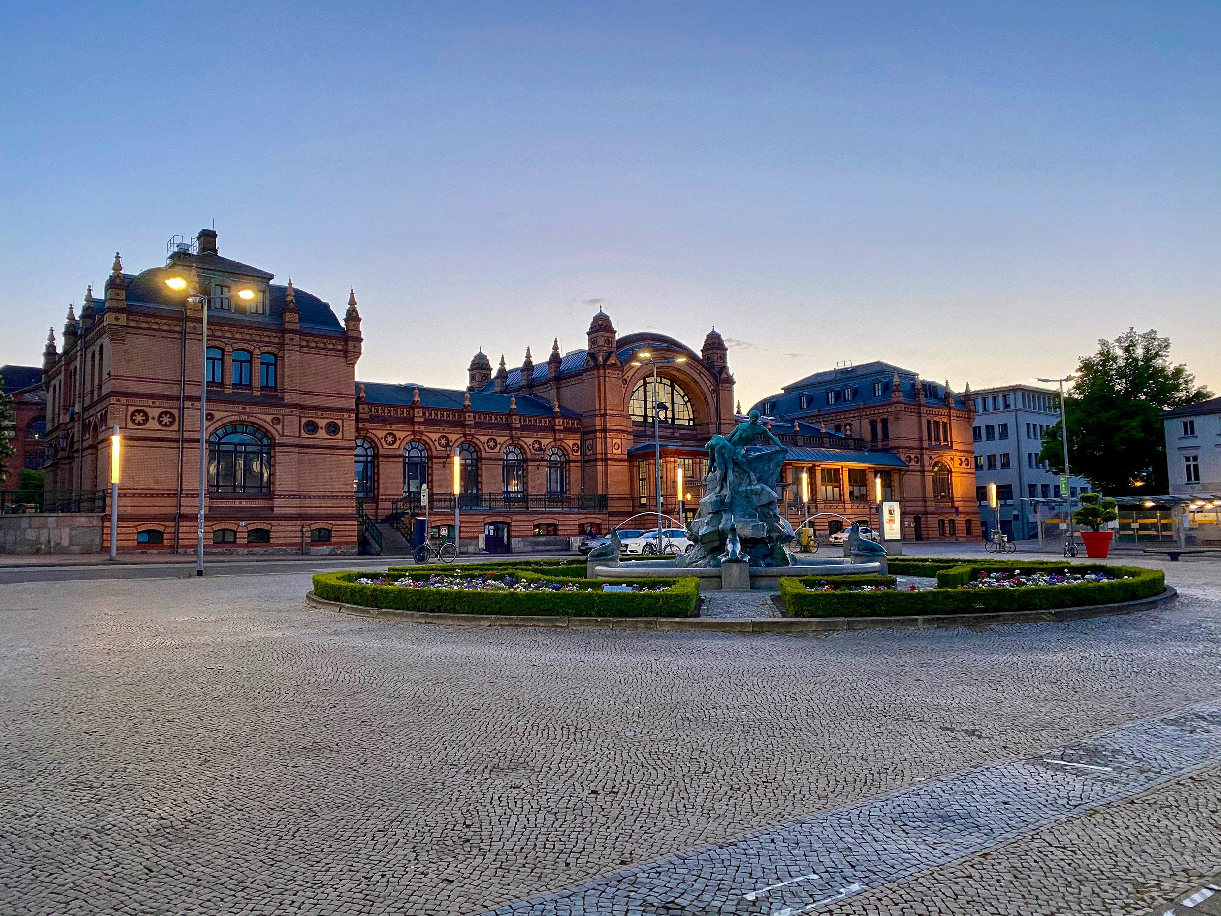 Town square with fountain and historic building in Schwerin, Germany HD Wallpaper