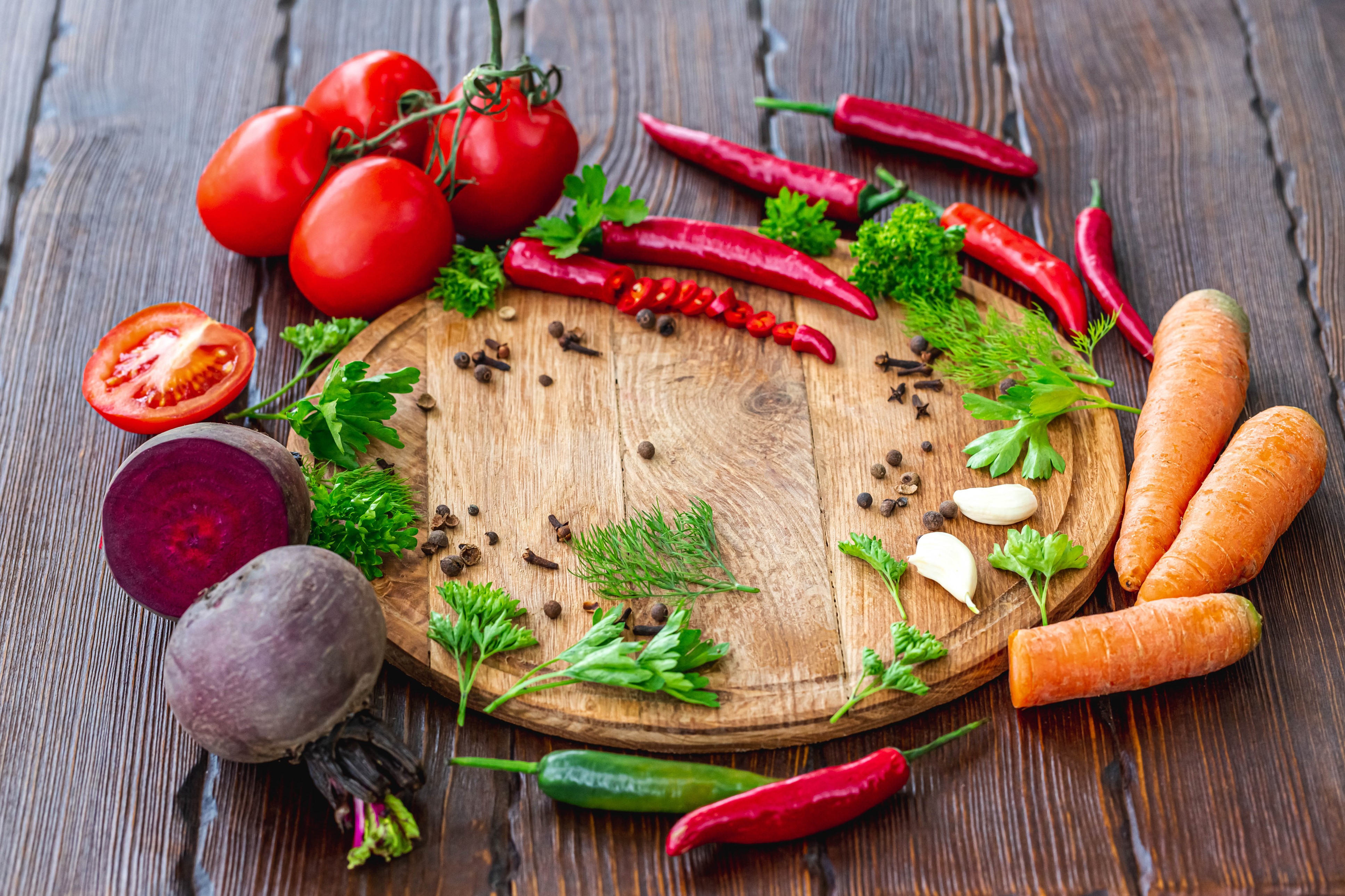 Vegetables and spices on a wooden cutting board HD Wallpaper
