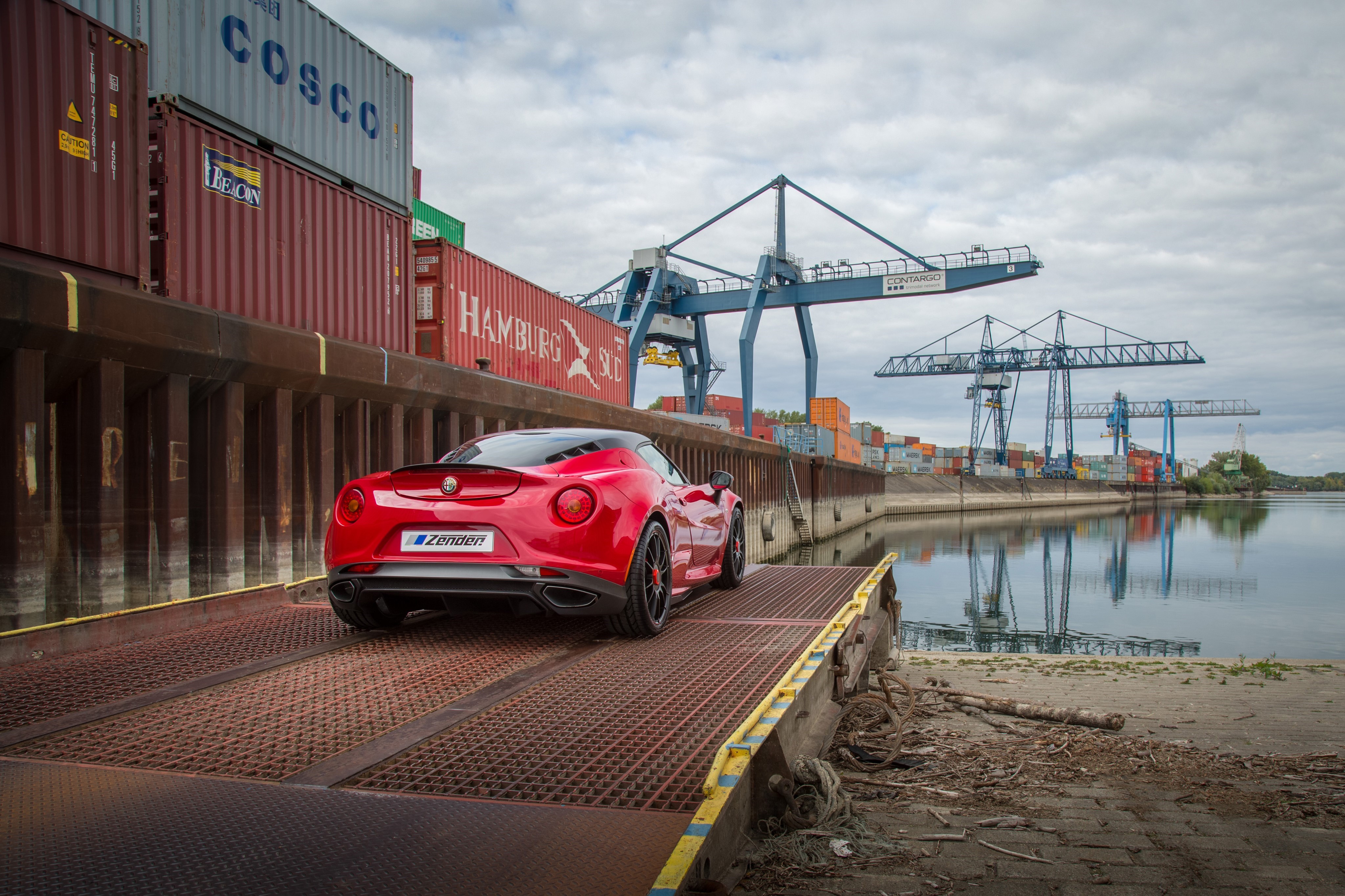Red Alfa Romeo 4C at a Shipping Port HD Wallpaper
