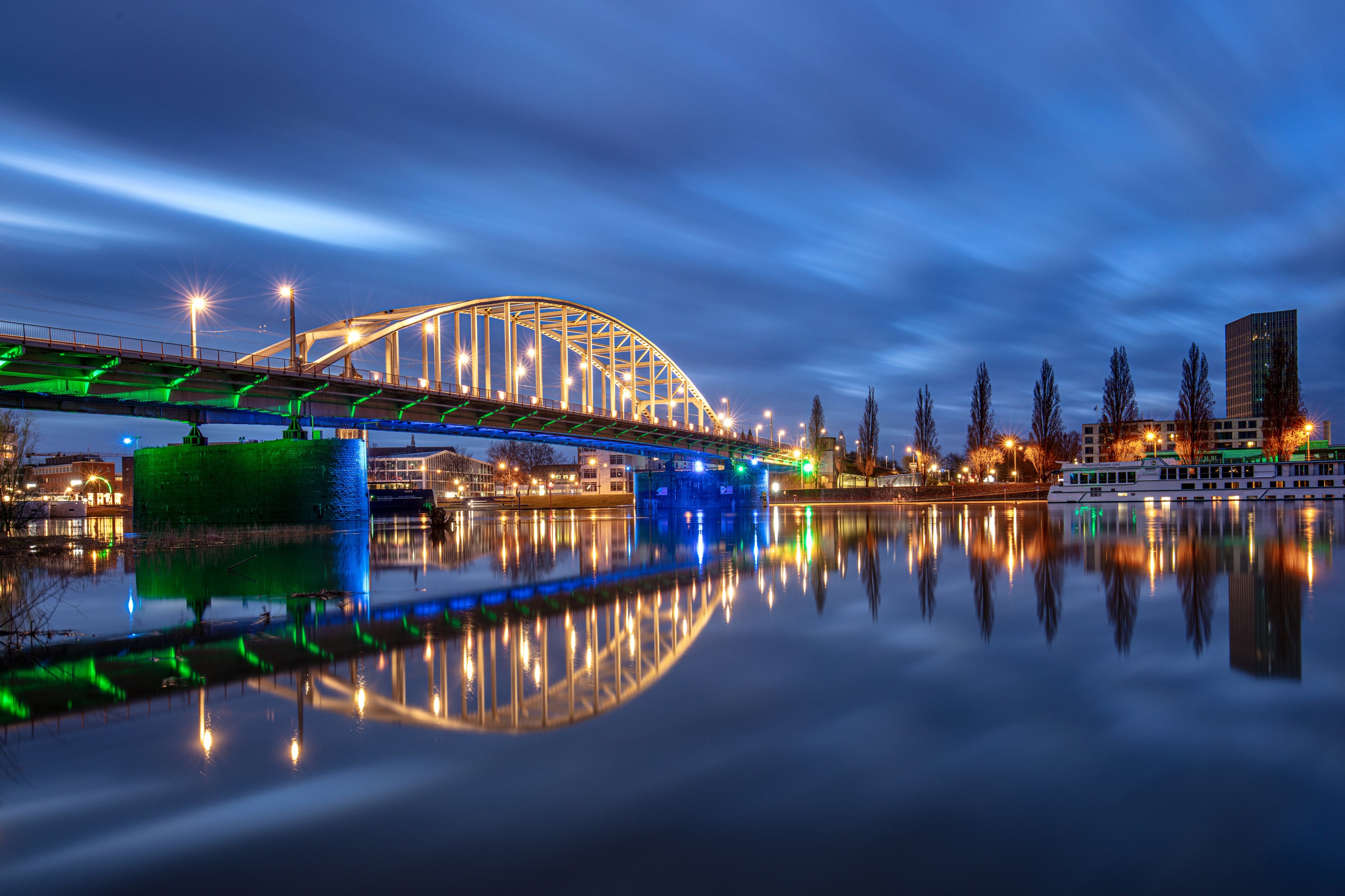 Bridge over river at night with reflections HD Wallpaper