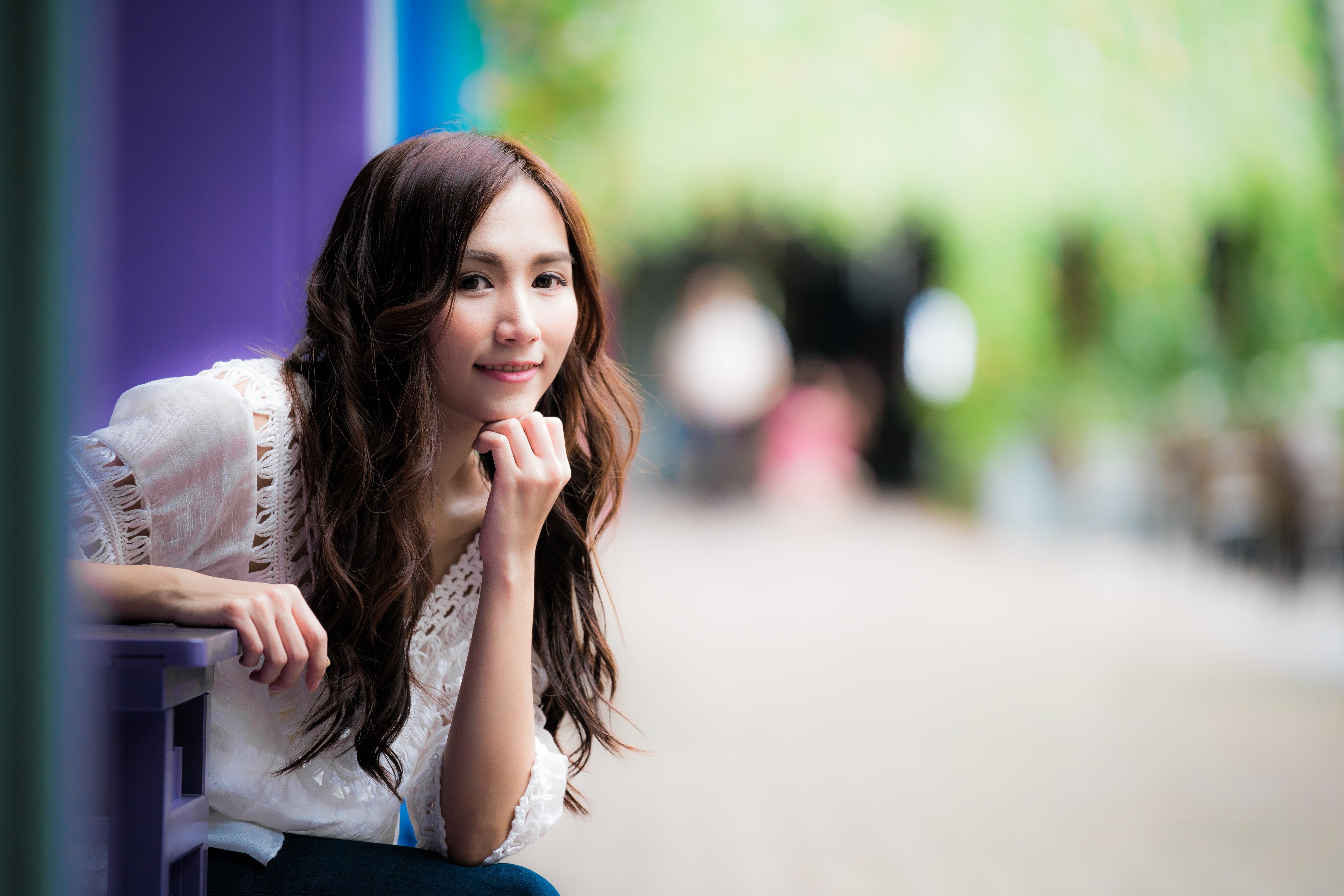 Asian woman with brown hair, resting chin on hand HD Wallpaper