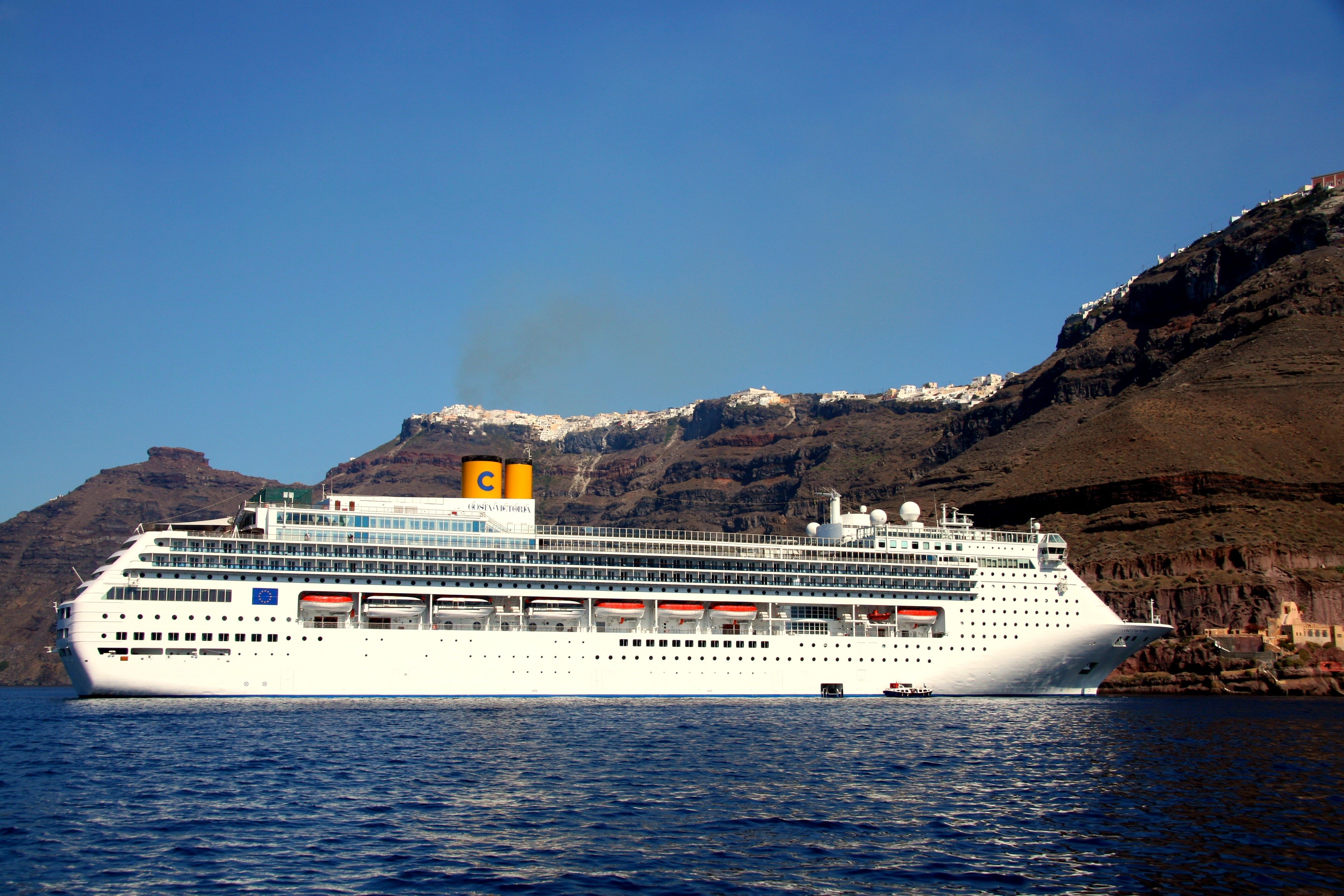 Costa Victoria cruise liner sailing near Santorini, Greece HD Wallpaper