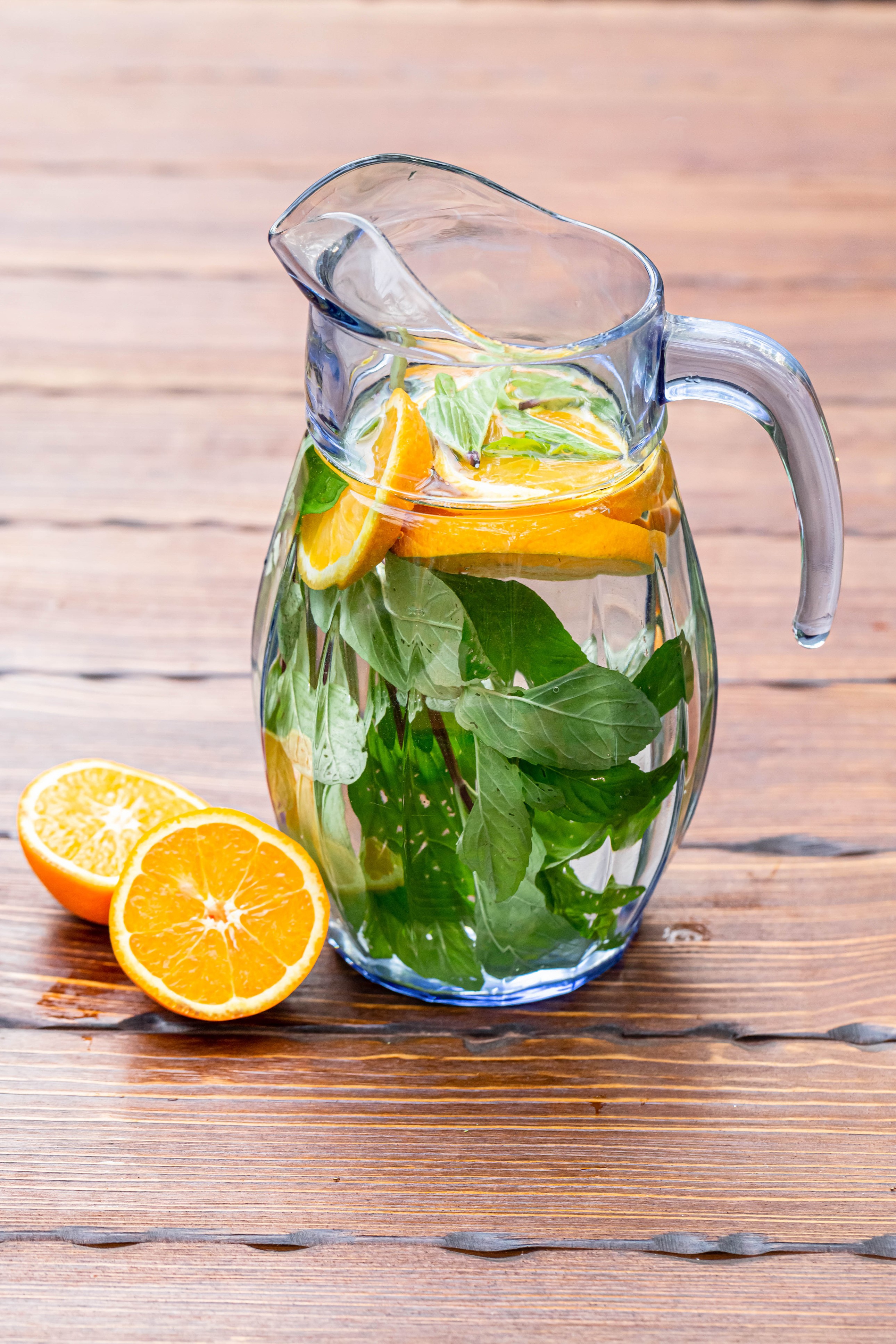 Pitcher of orange and mint infused water on wood HD Phone Wallpaper