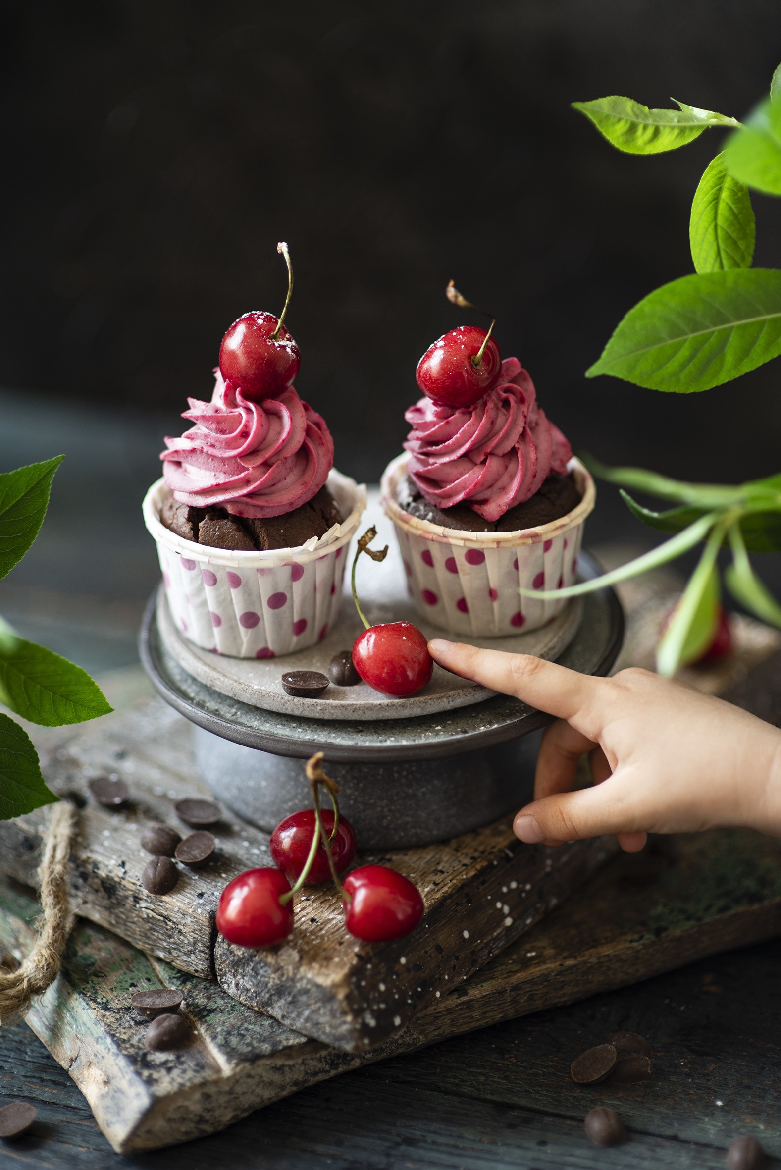 Two chocolate cupcakes with cherry frosting and cherries HD Phone Wallpaper