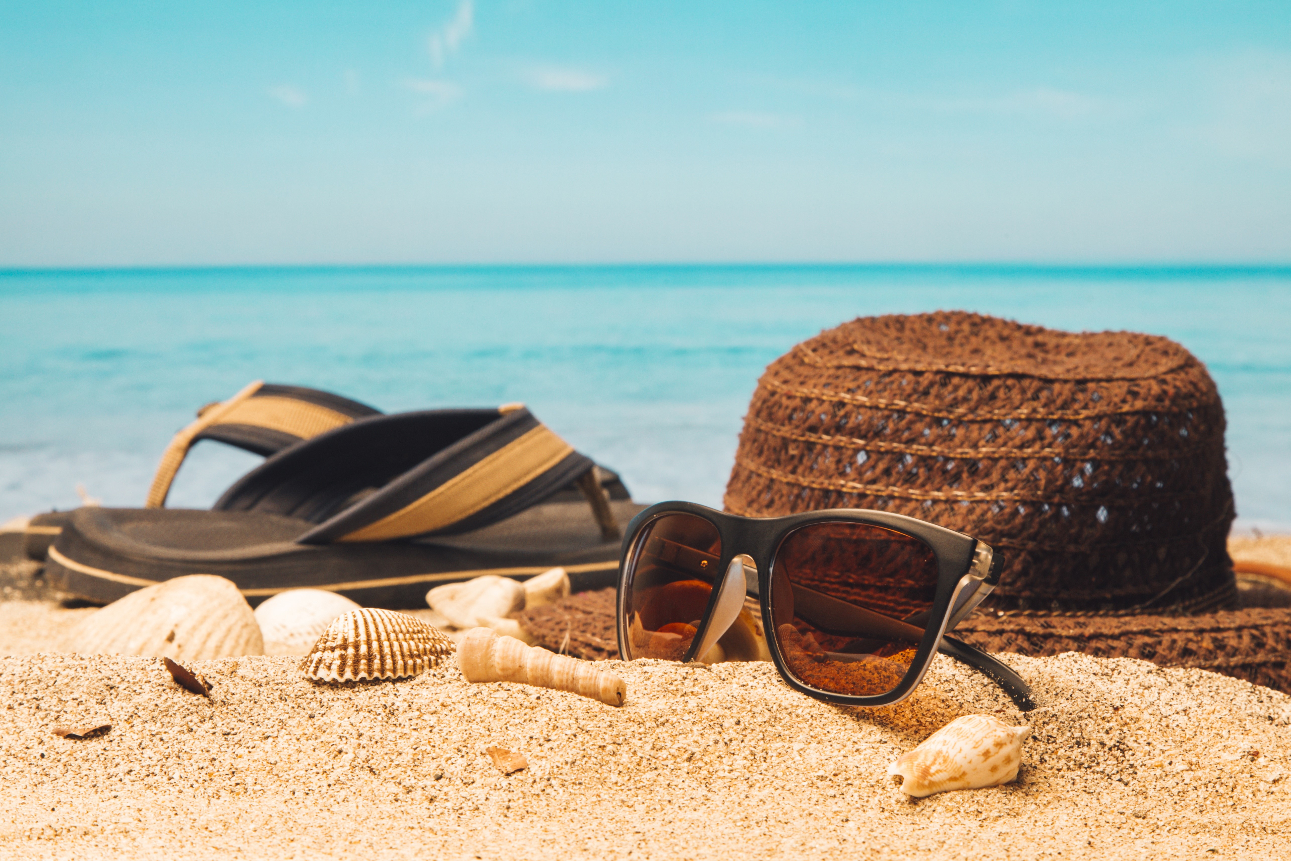 Summer beach scene with flip-flops, sunglasses, and hat HD Wallpaper
