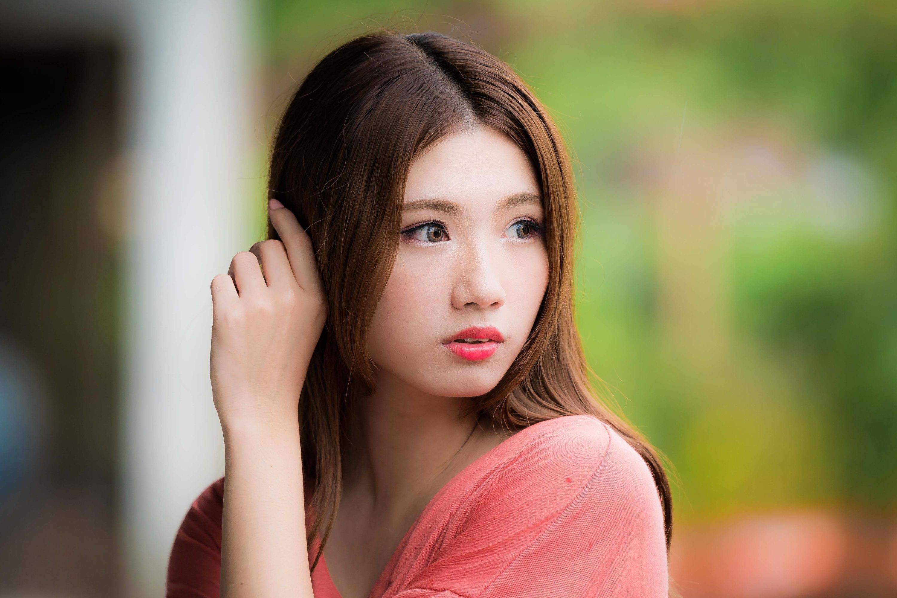 Asian woman with brown hair touching her ear HD Wallpaper