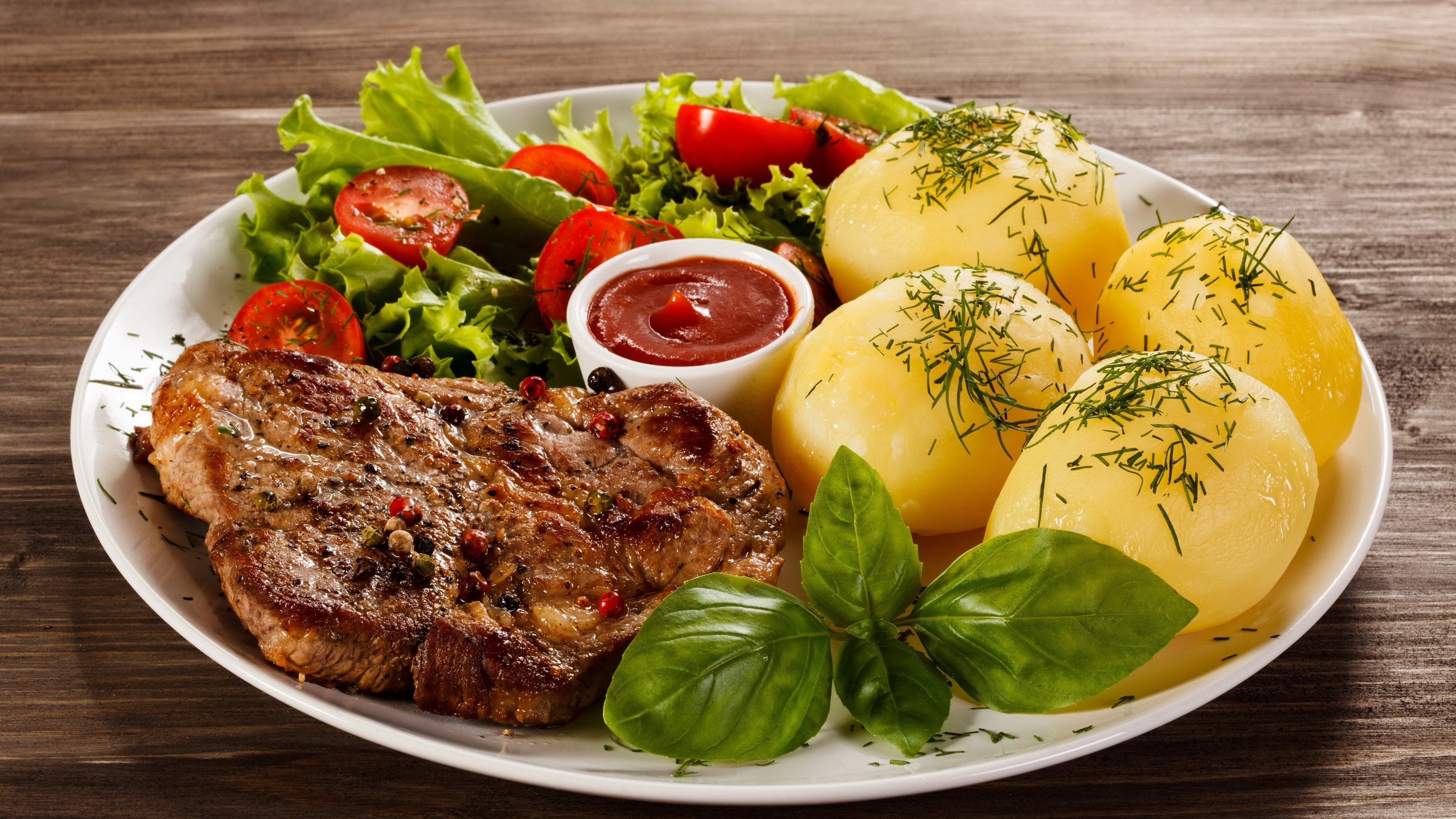 Steak with potatoes, salad, and ketchup on a plate HD Wallpaper