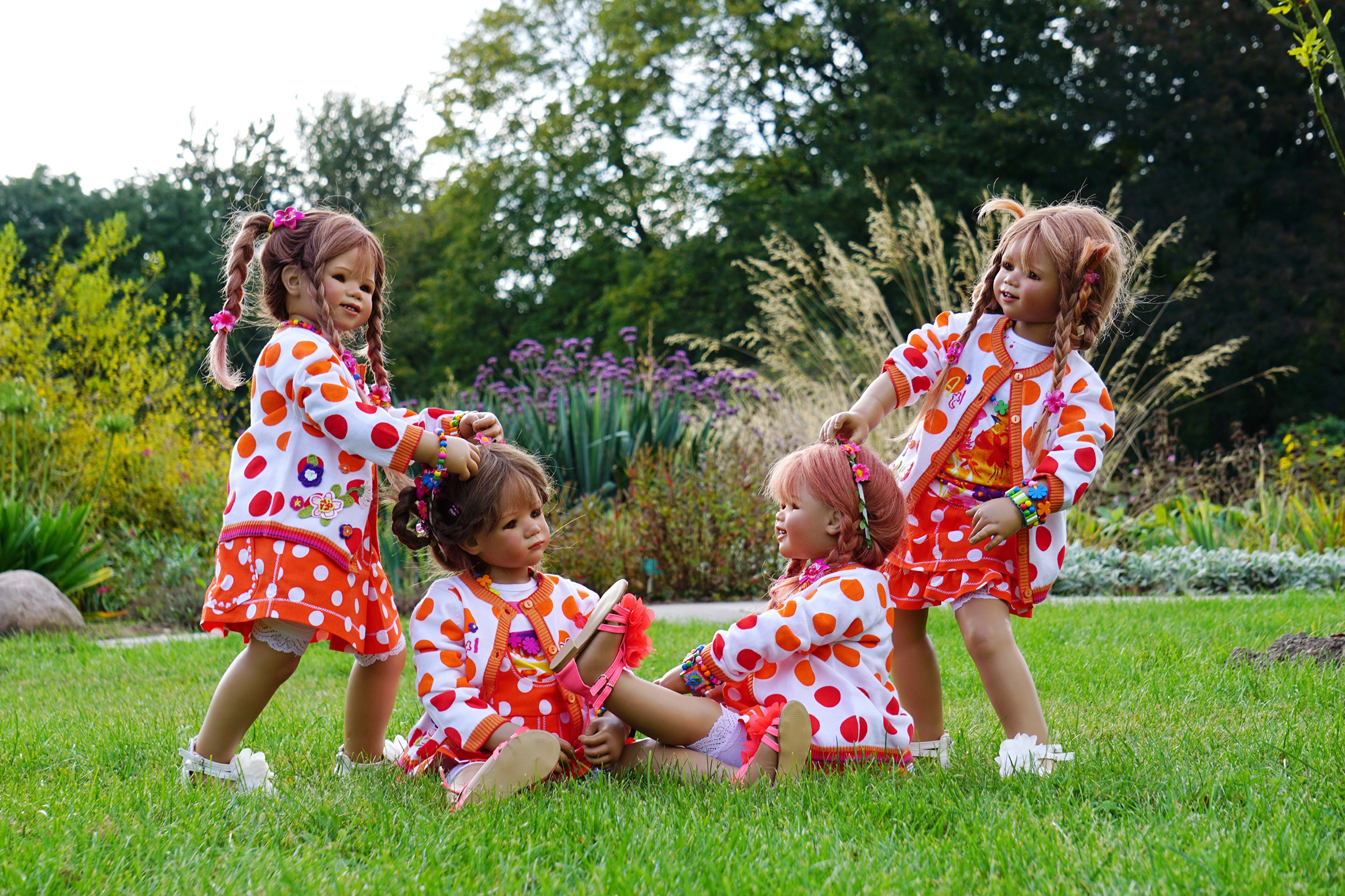 Four dolls playing in a park in Germany HD Wallpaper