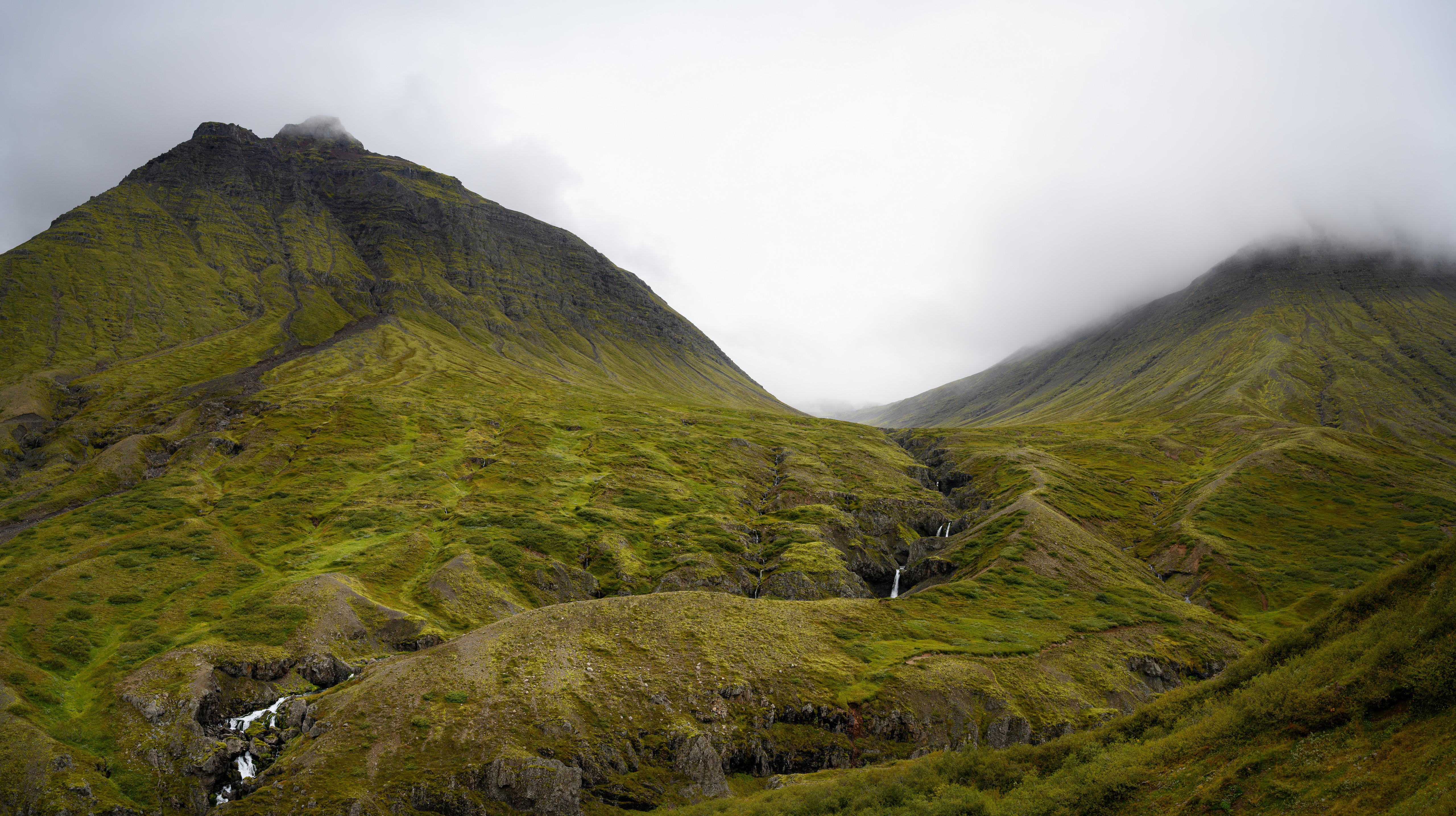 Green mountains with waterfalls in Iceland under clouds HD Wallpaper