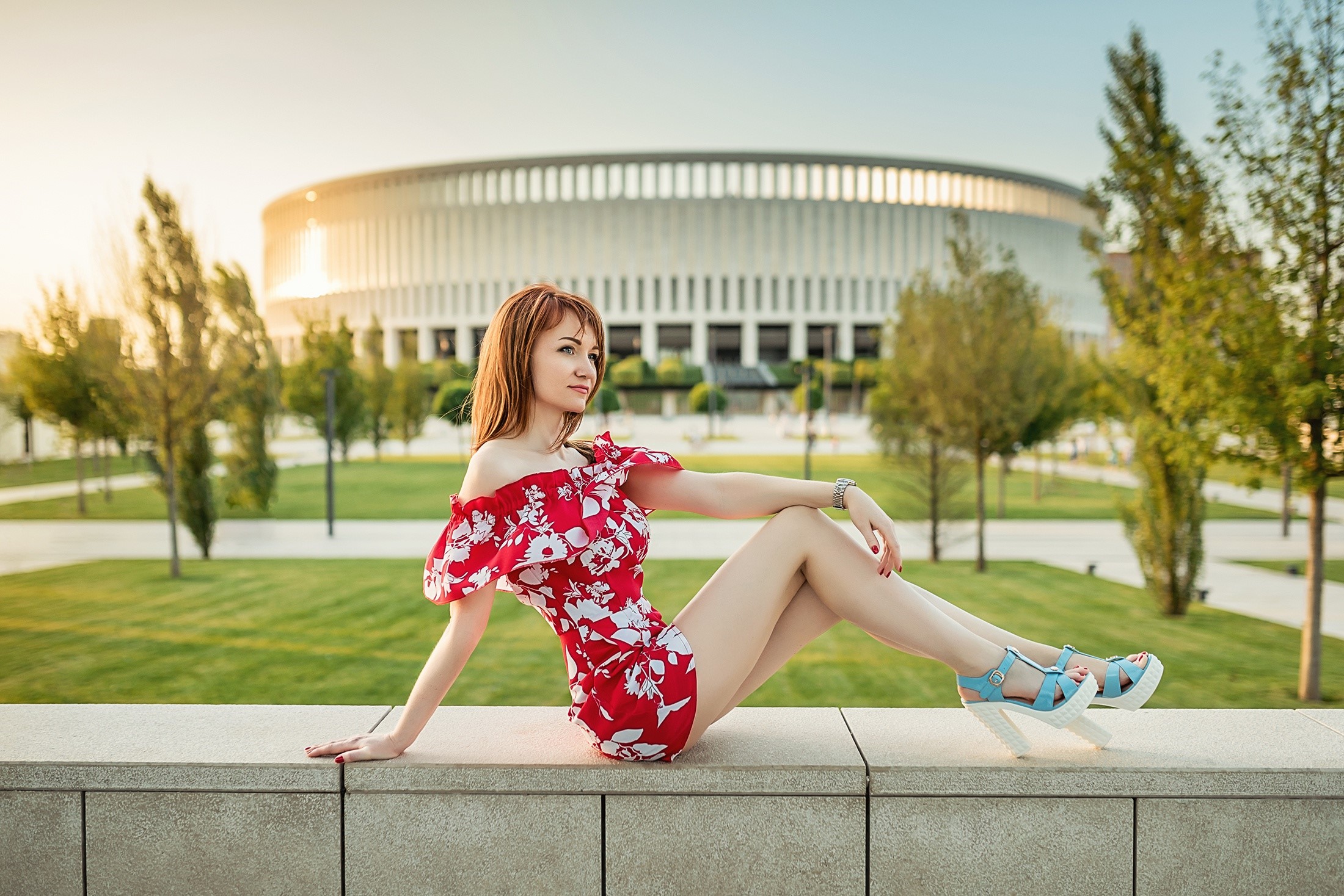 Redhead girl in red dress sitting near stadium HD Wallpaper