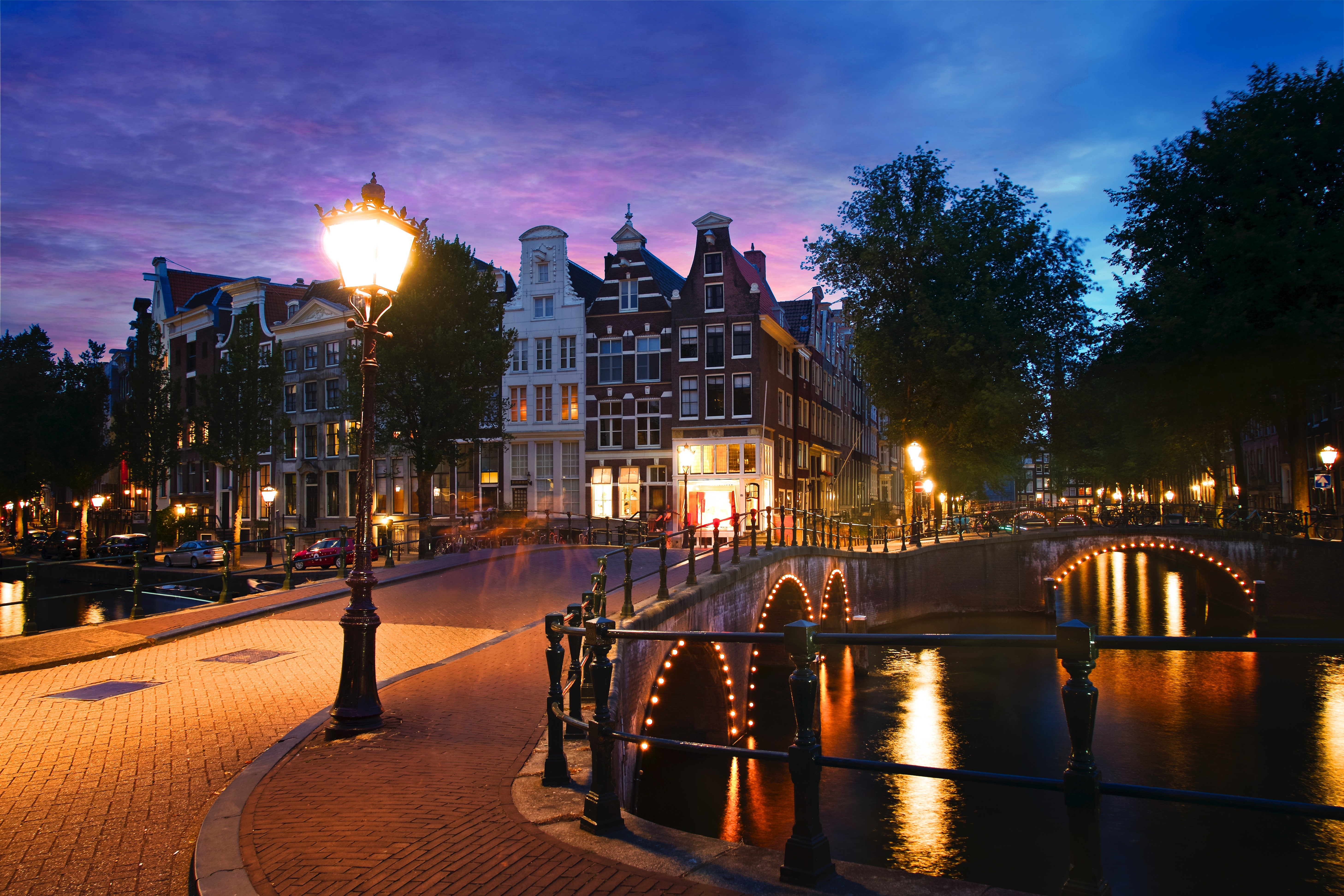 Amsterdam canal with bridges and houses at dusk HD Wallpaper