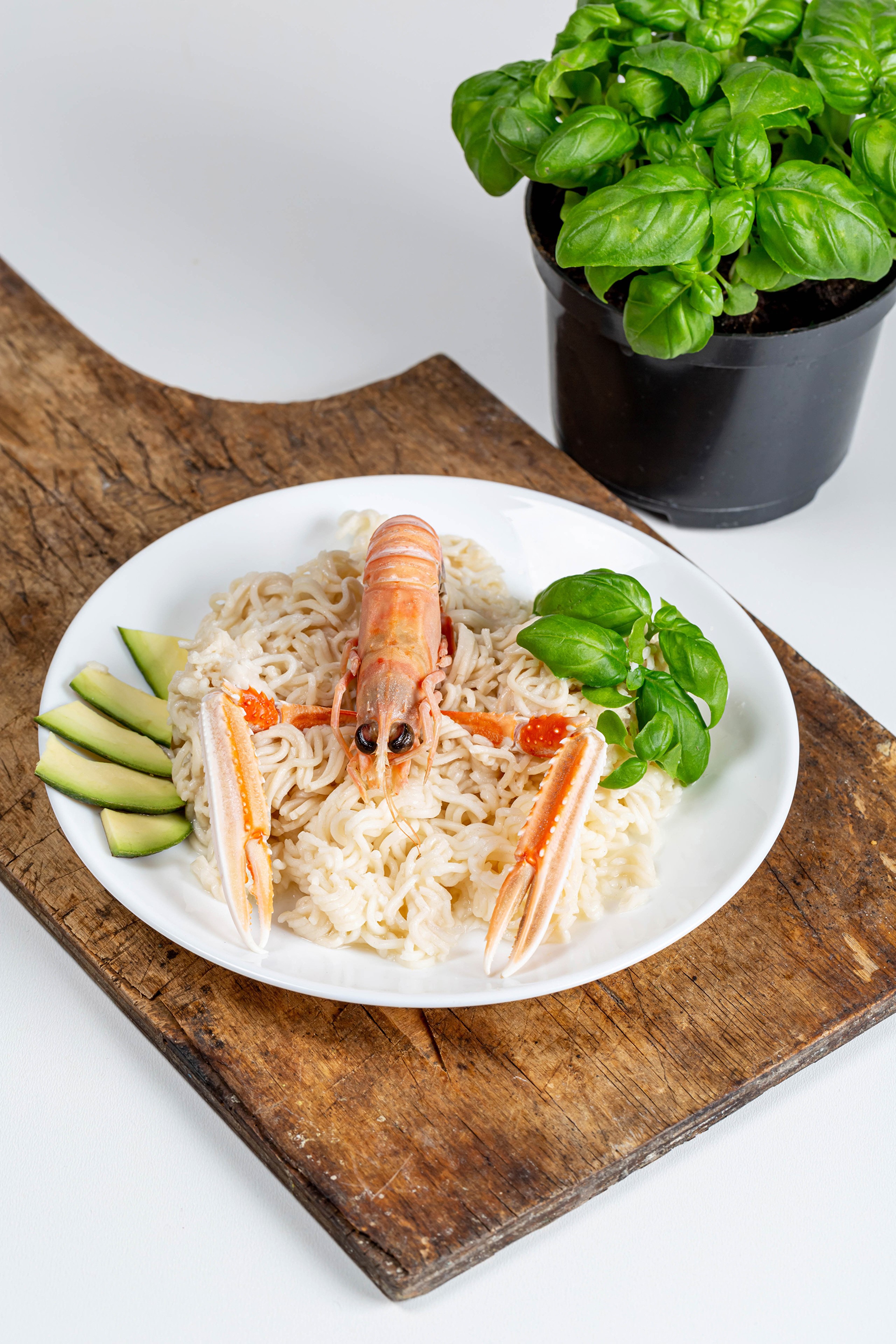 Scampi pasta with avocado and basil on a cutting board HD Phone Wallpaper